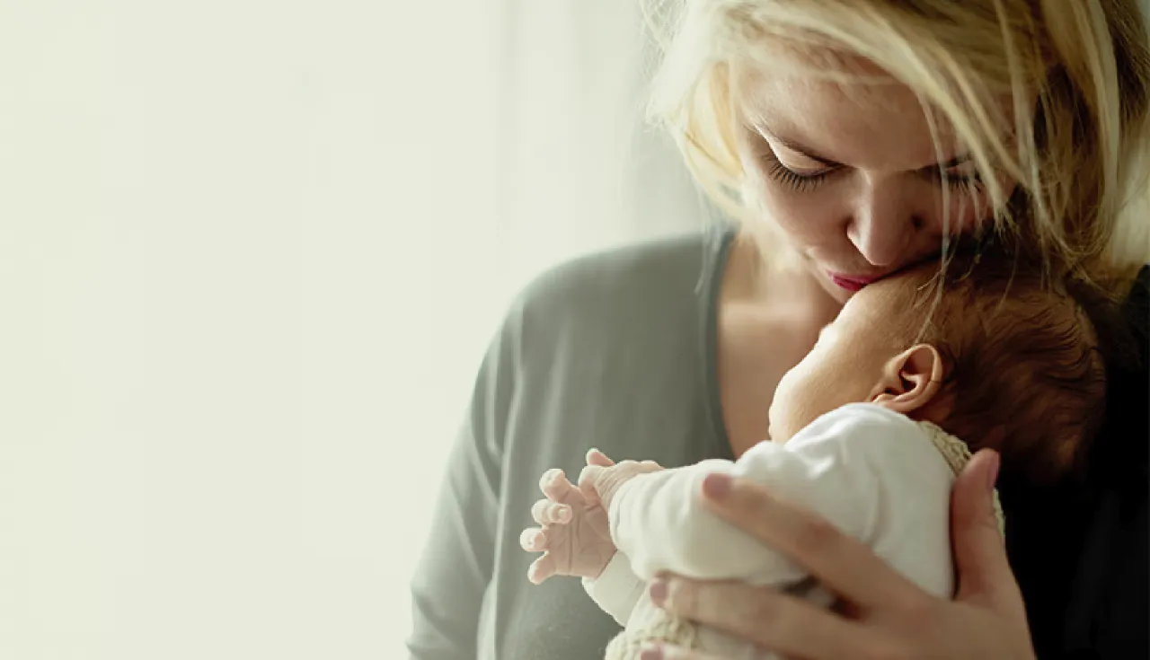 Woman with her baby representing the postpartum care path