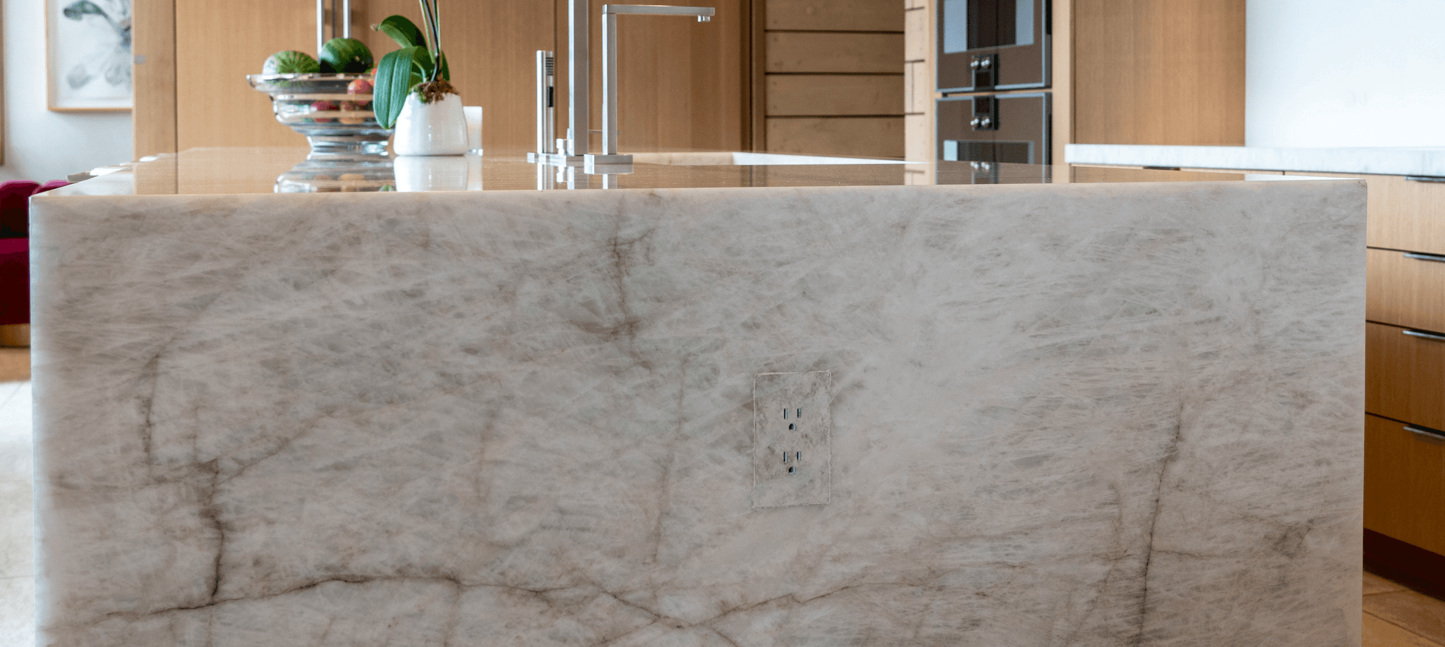 Trufig flush mount outlet installed in marble kitchen island for seamless architectural integration in luxury residential project in British Columbia