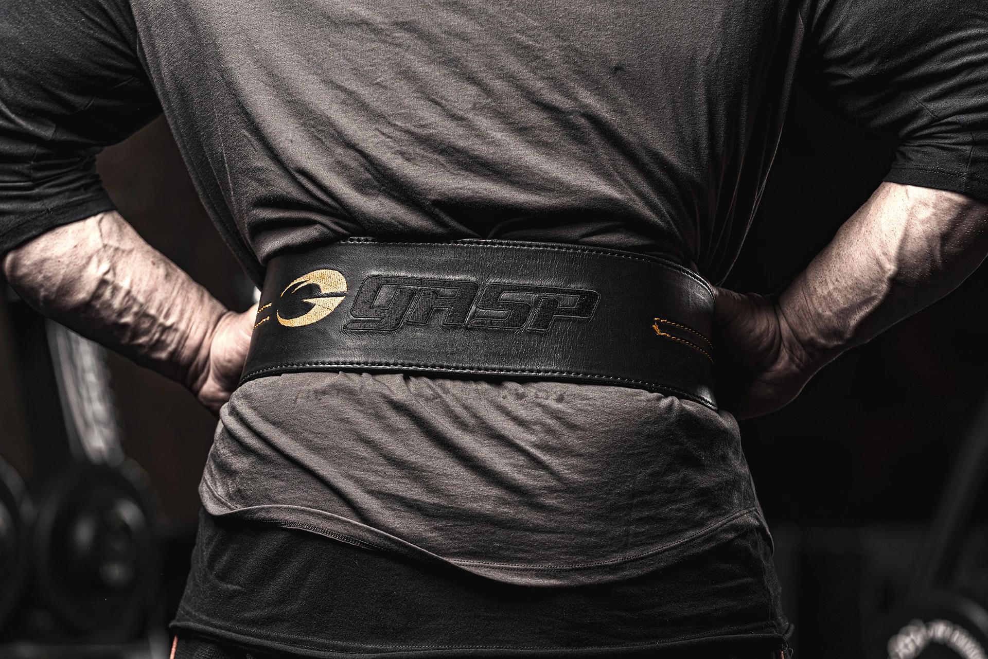 A man with a black Gasp workout and lifting belt.