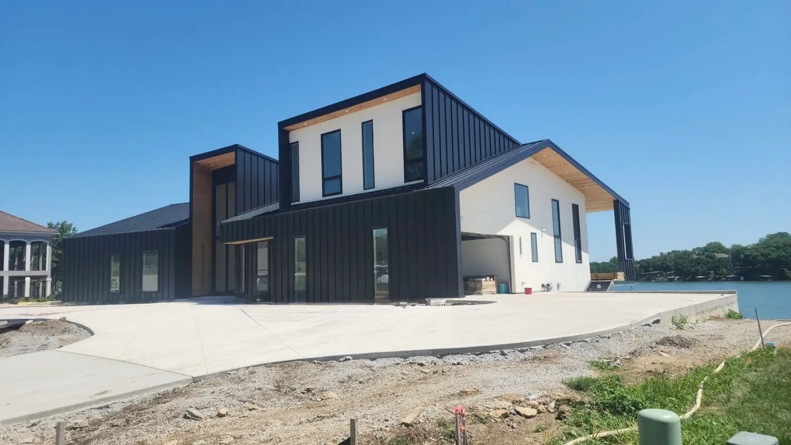 An image of a large black house with white accents.