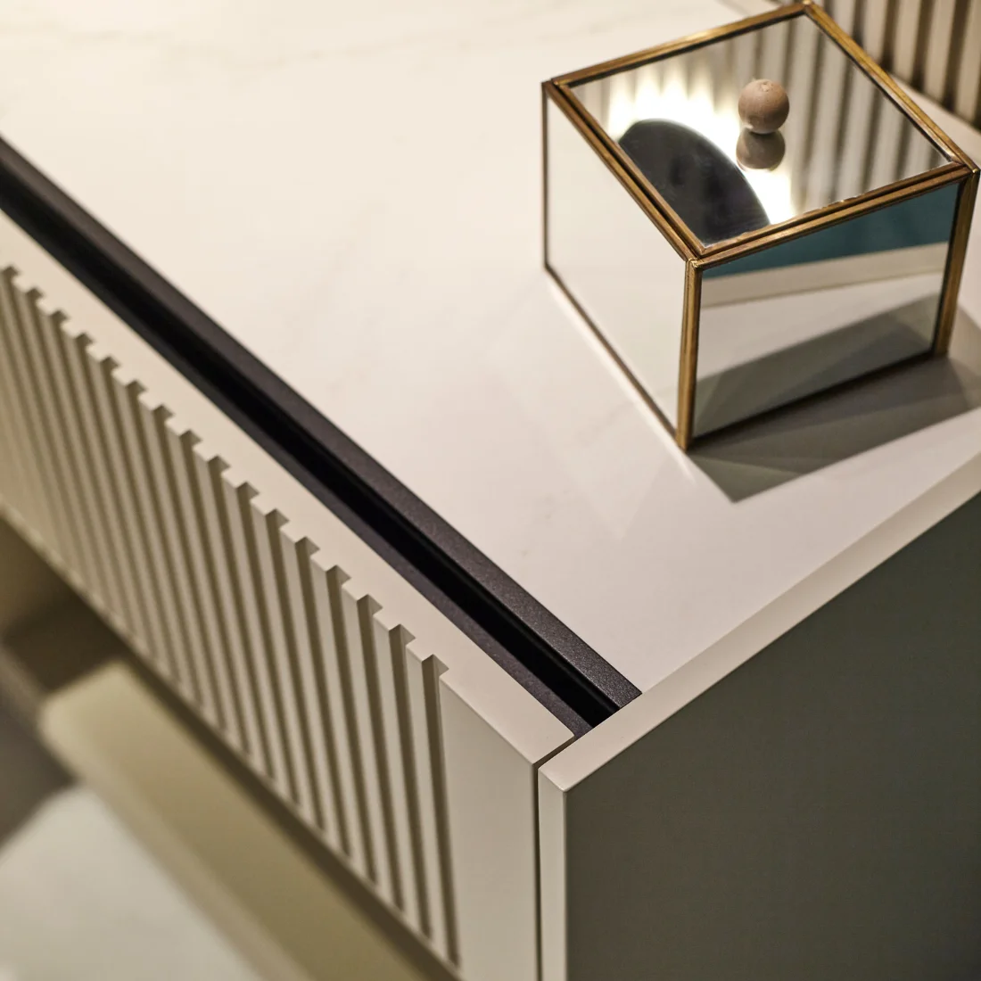 People relaxing in a sunlit lobby with large windows