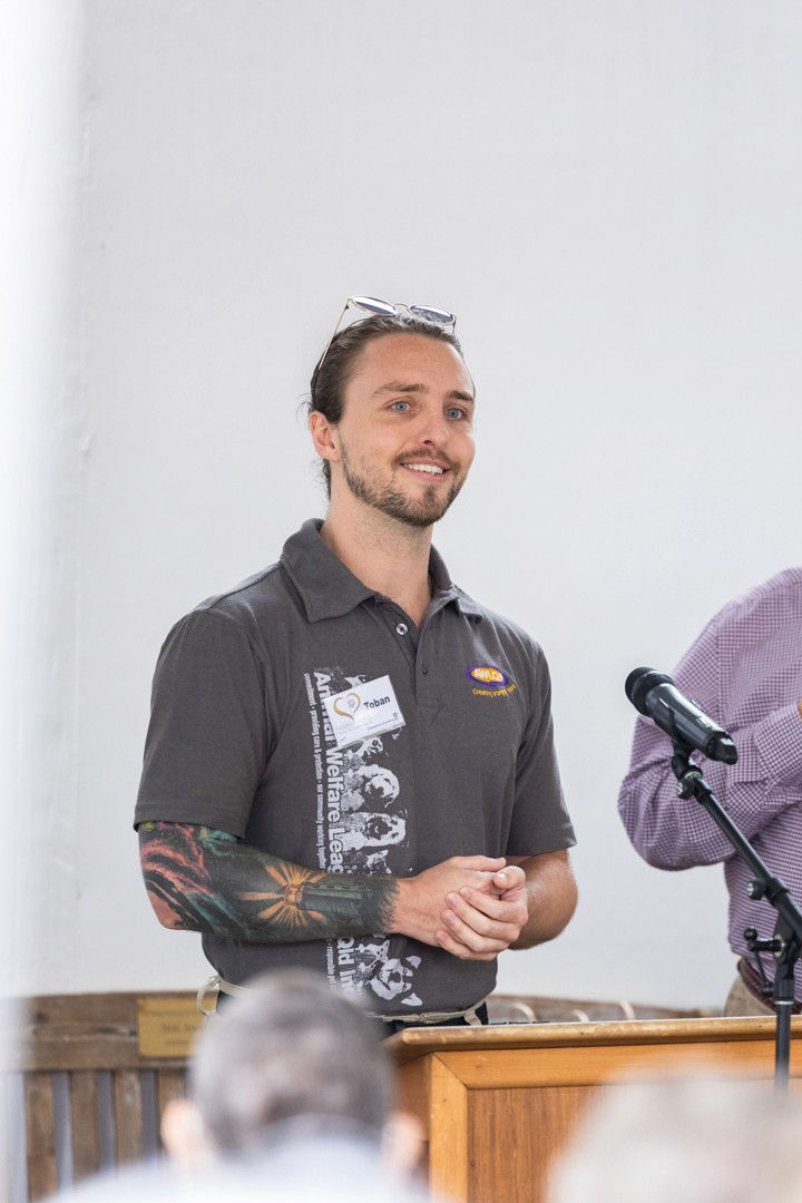 Young man speaking into microphone at podium