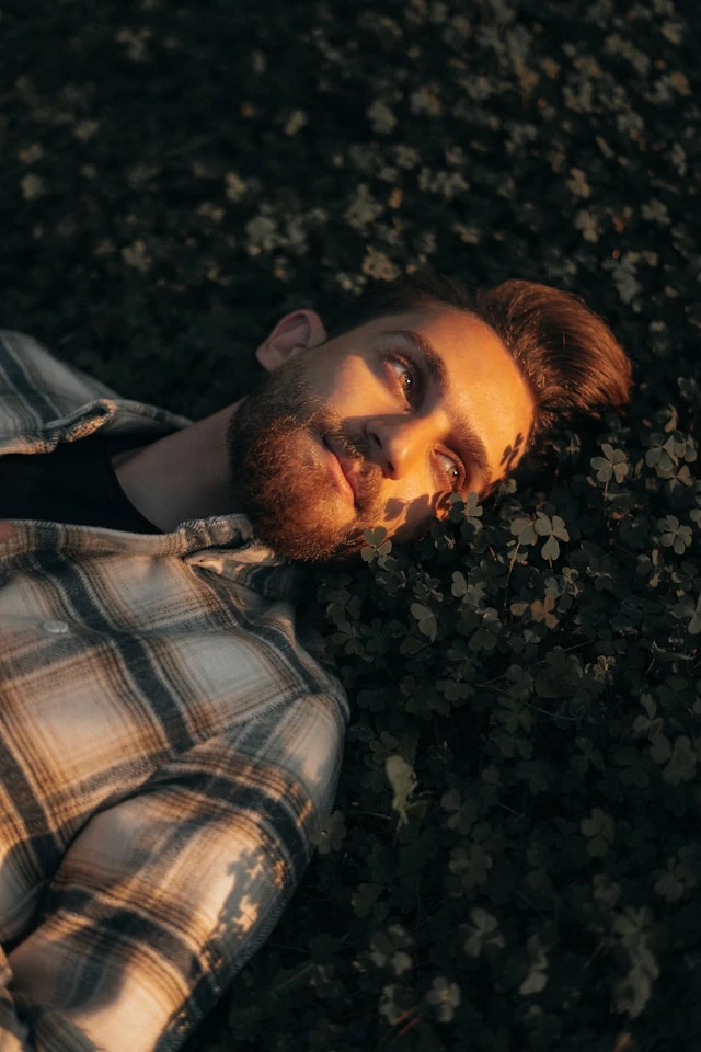 Man resting with his eyes closed in low light