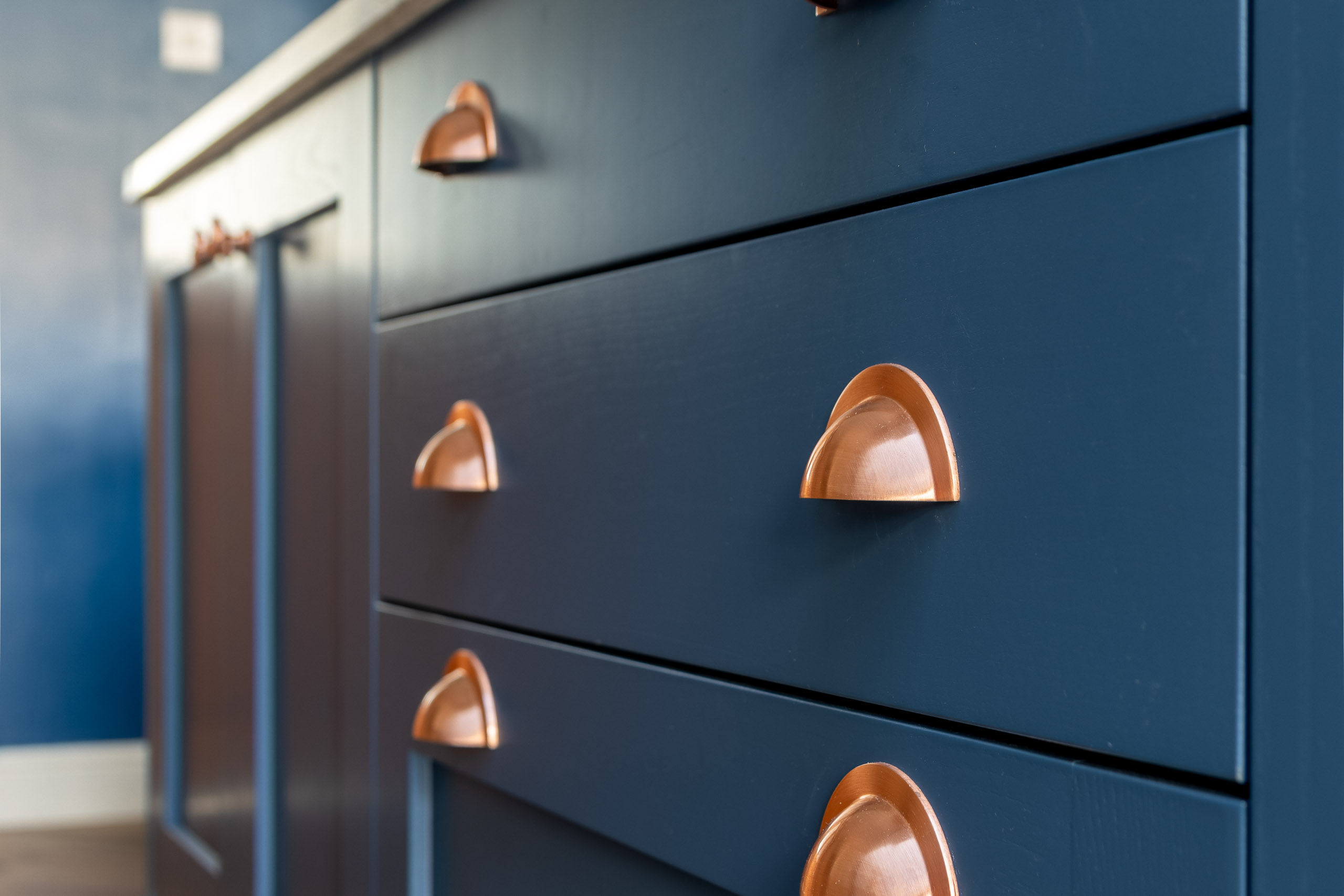 blue shaker kitchen with copper handles