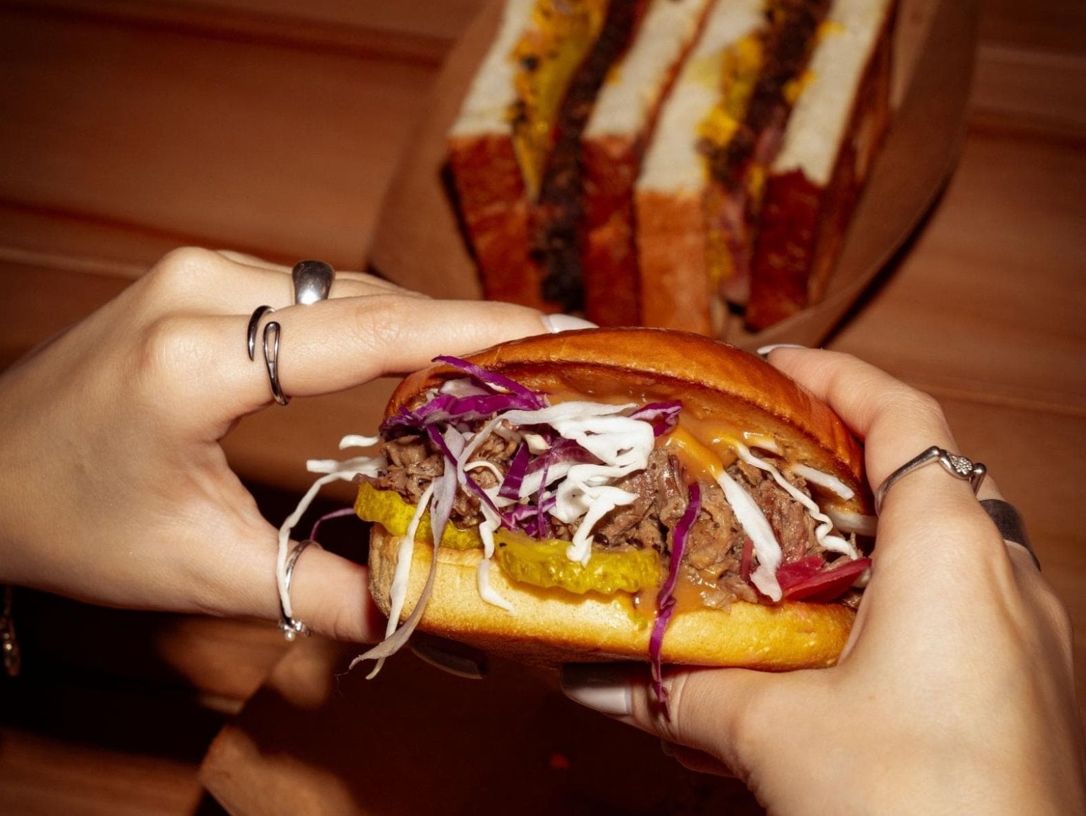 BBQ restaurant dubai featuring a Texas-style brisket sandwich with slow-smoked beef, finished with rich barbecue flavour.