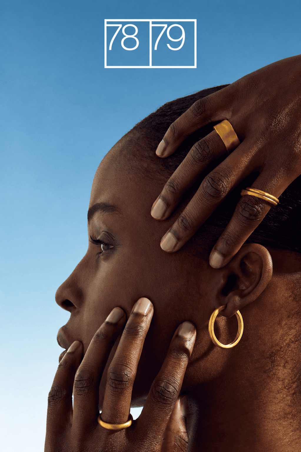 Model wearing gold jewelry in a minimalist 78/79 fashion brand ad.