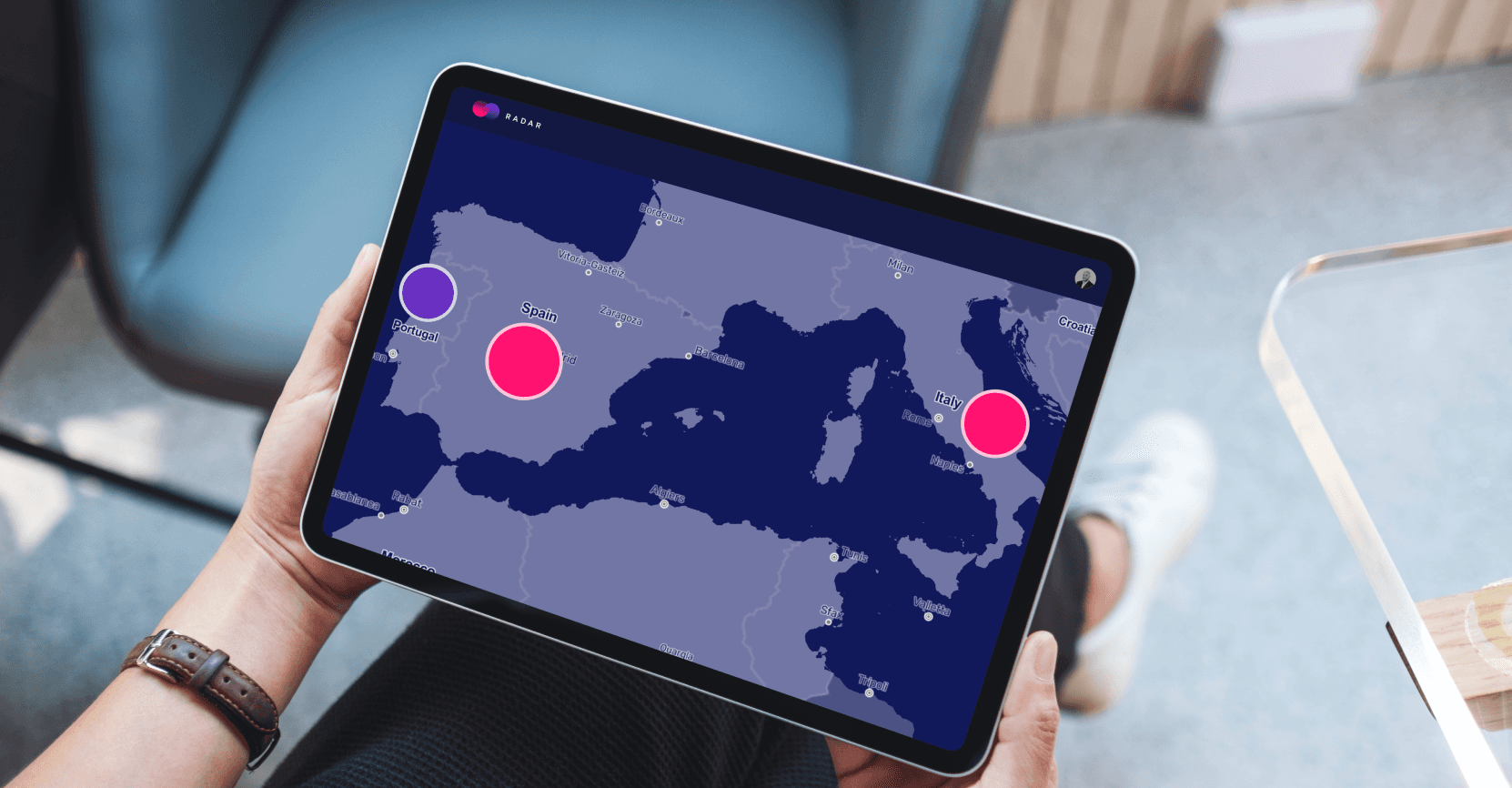 A tablet screen displaying a map of Southern Europe with large circular data points over Portugal, Spain, and Italy. The Radar platform highlights regions with significant talent pools.