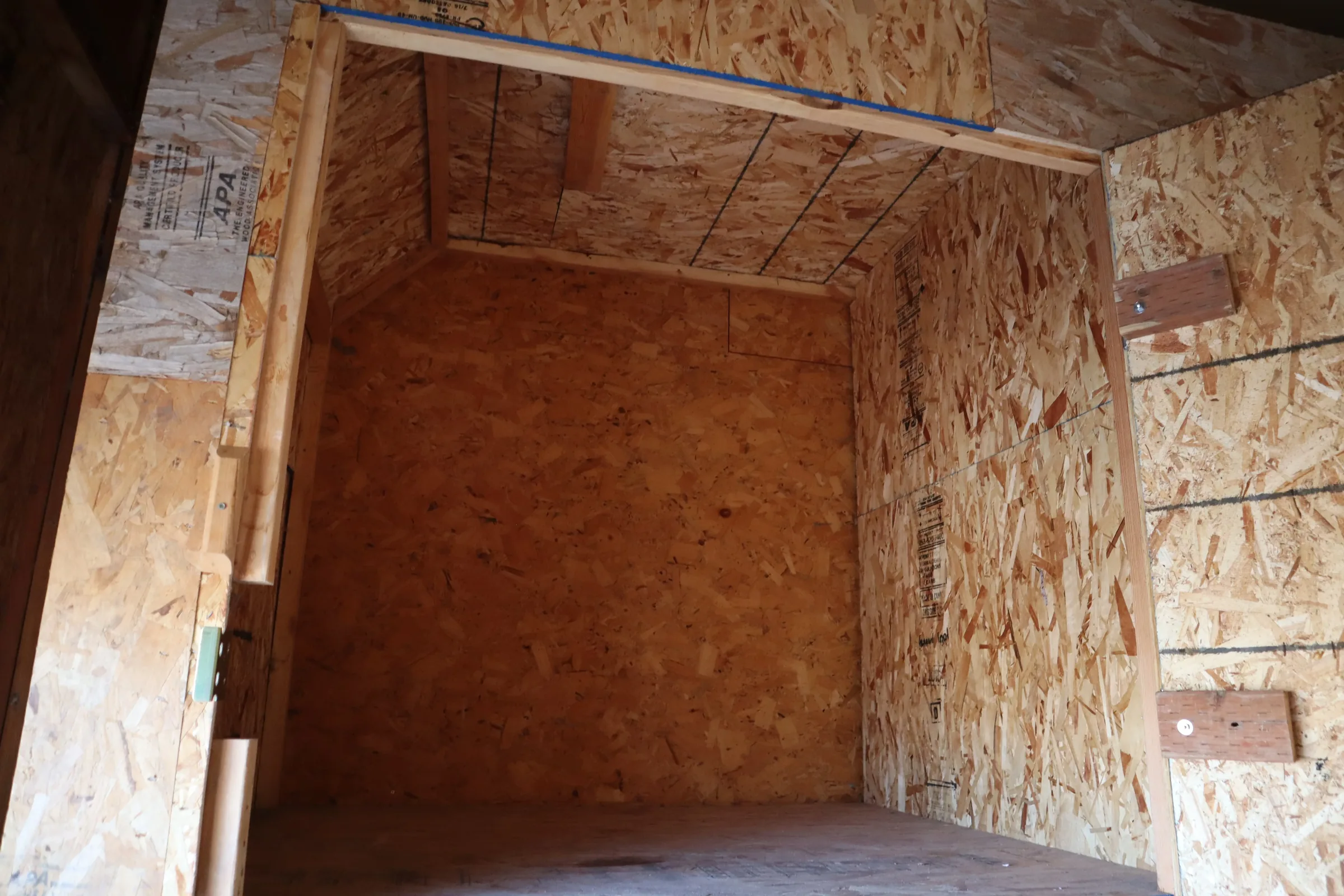 Empty wood-paneled storage locker