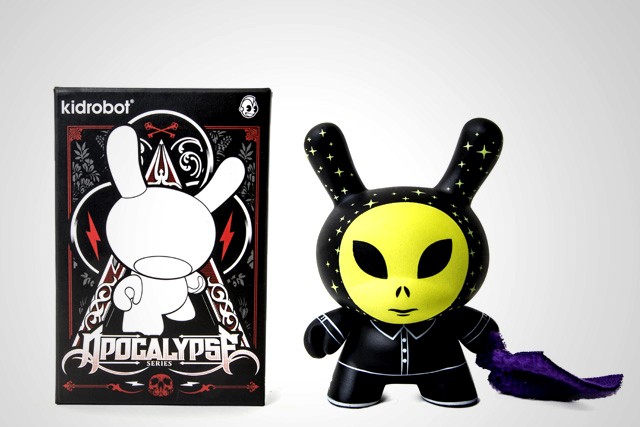 a small alien figurine painted in neon green with the hood with small stars painted with glow in the dark green