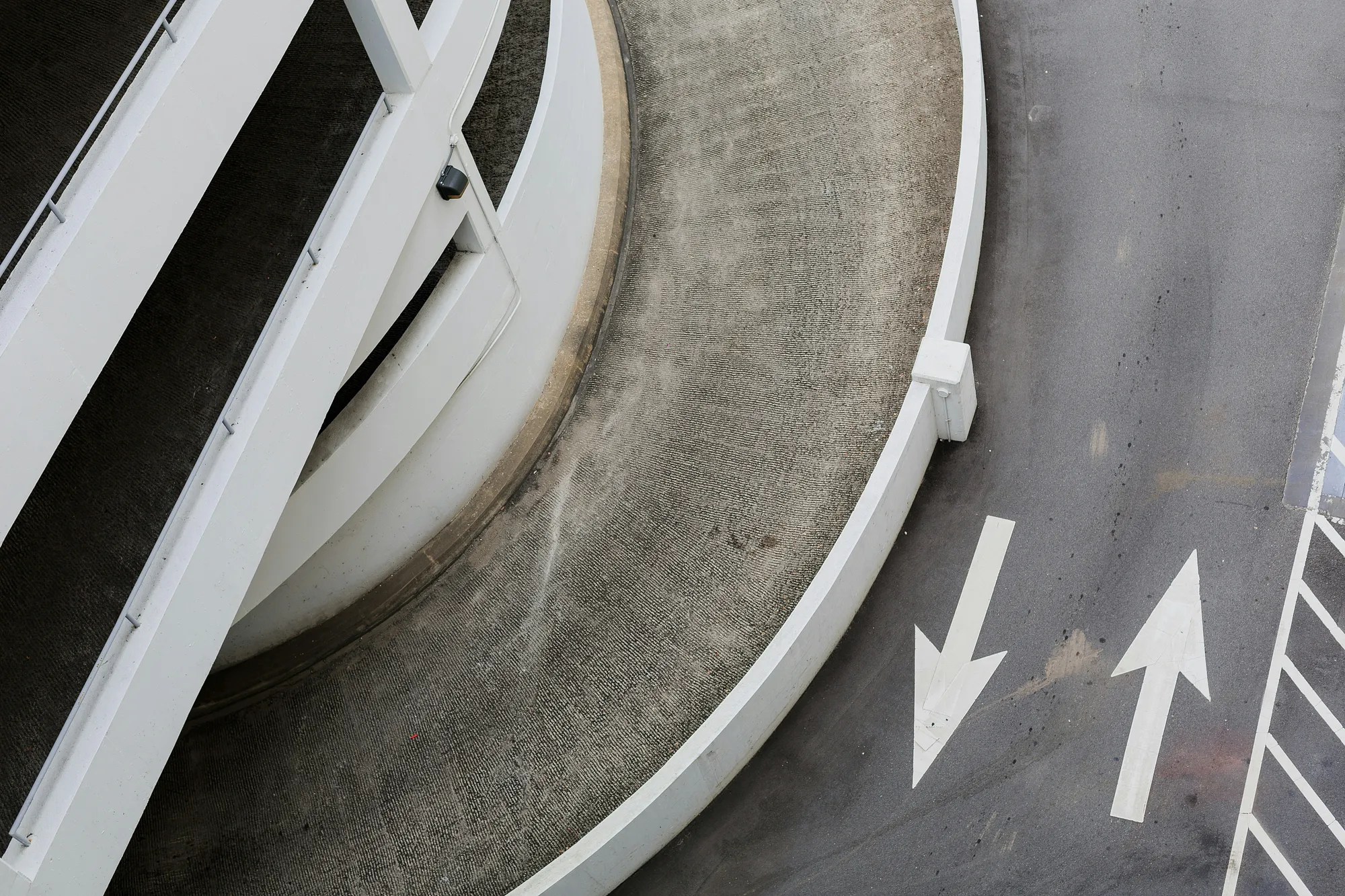 Multi-story car park entrance with arrows painting on the tarmac