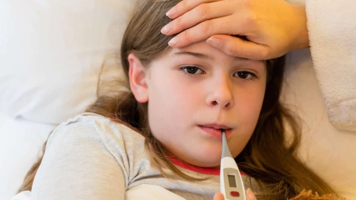 Small girl with thermometer in mouth