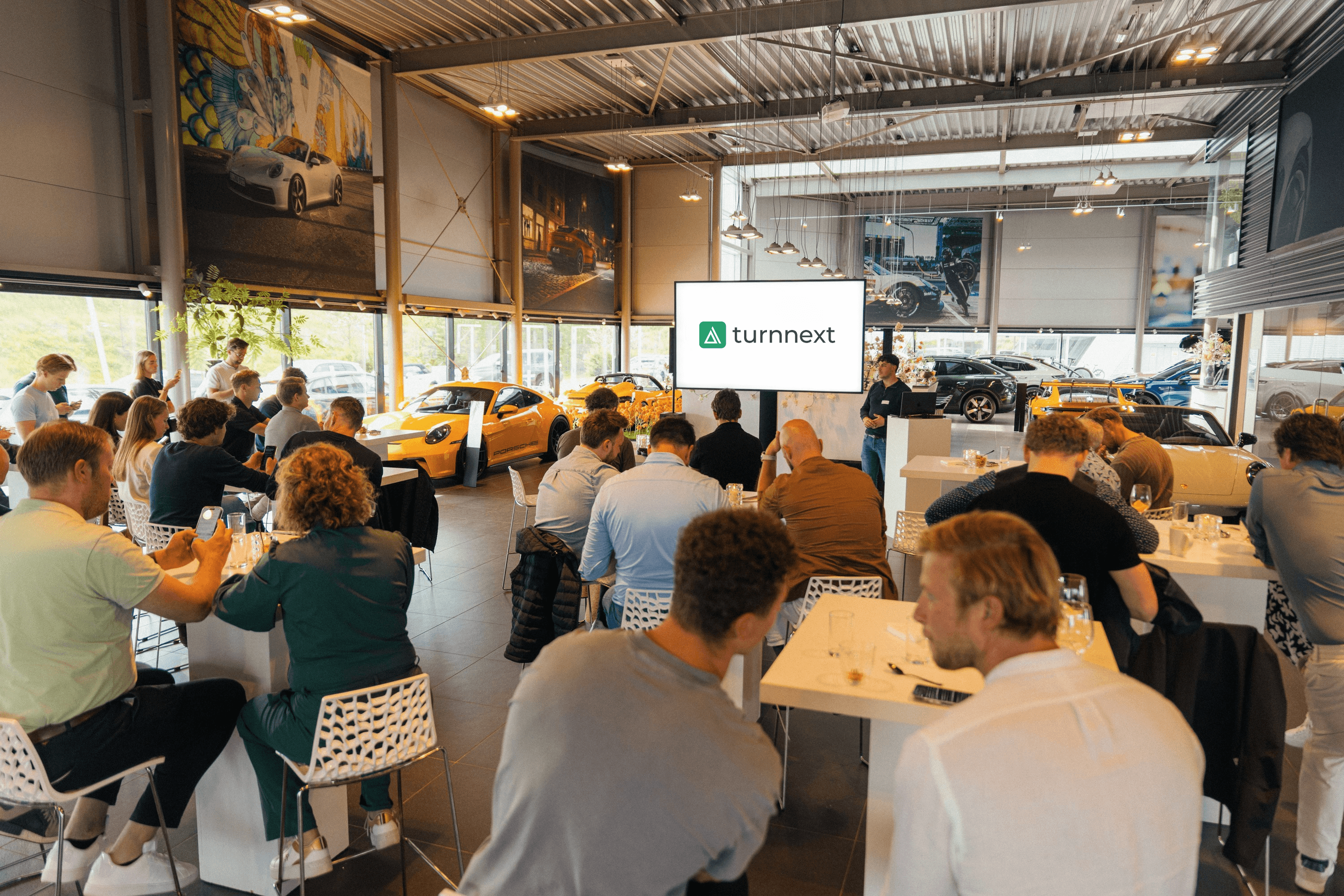 A presentation of the services by turnnext at a porsche dealership