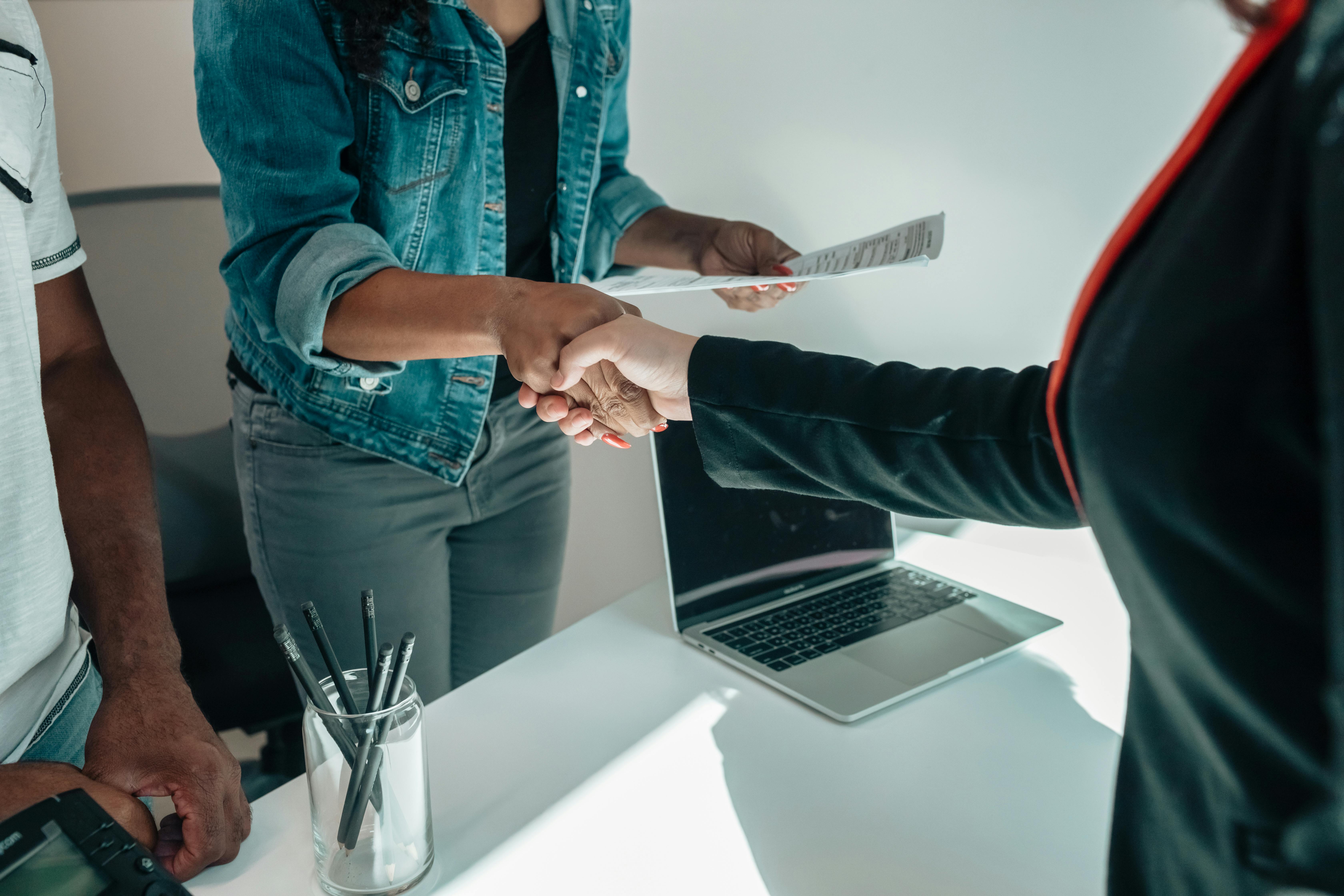 two-people-shaking-hands-over-a-desk-signifies-a-business-agreement-or-partnersh - kindel-media (pexels)
