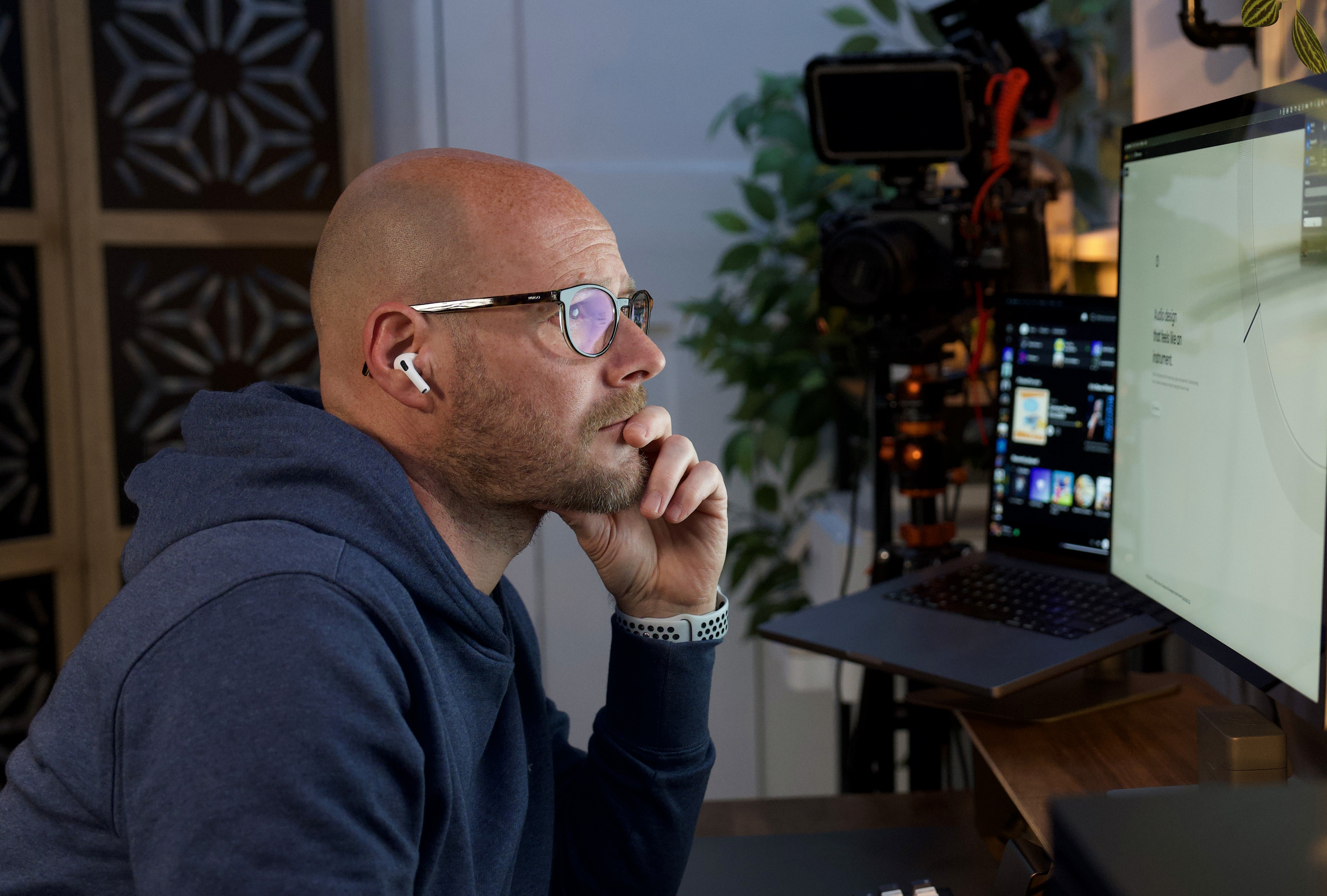 Mark Bennett looking at a screen desigining.