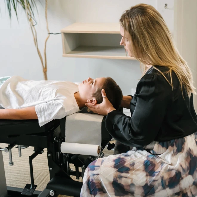 Teenager getting chiropractic adjustment