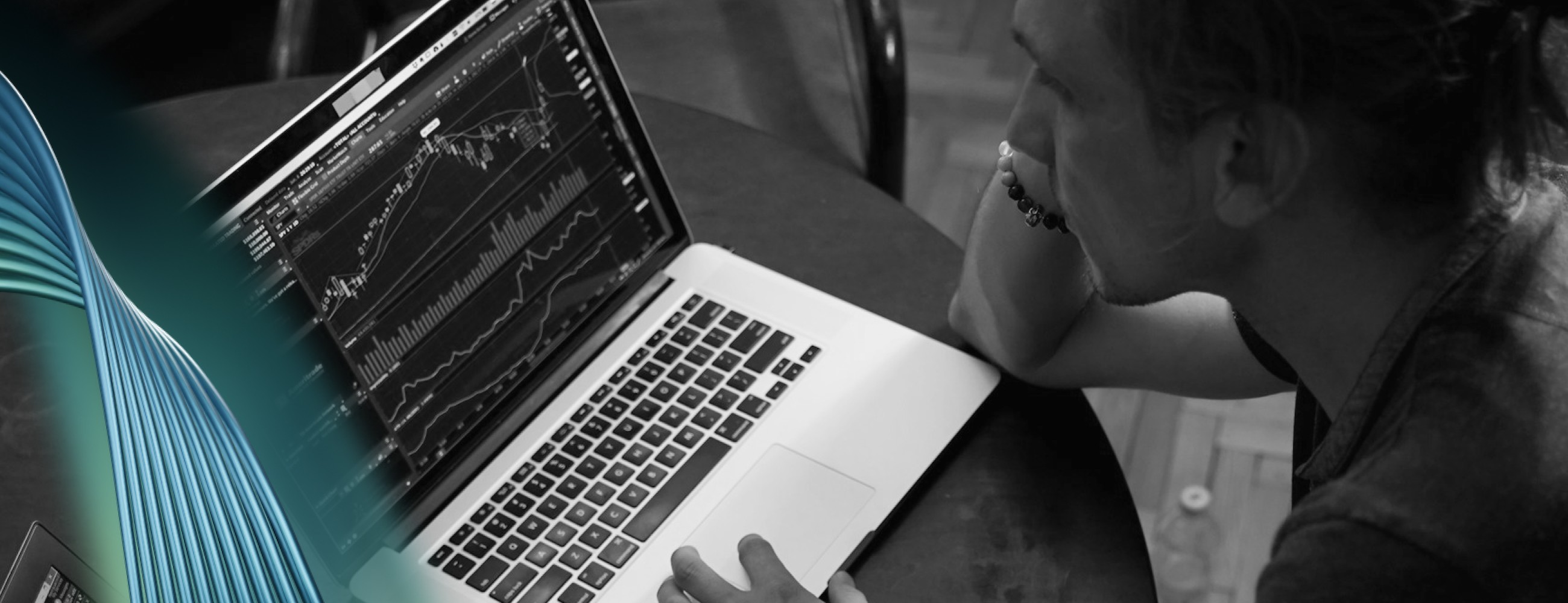 person on a laptop, laptop showing graphs