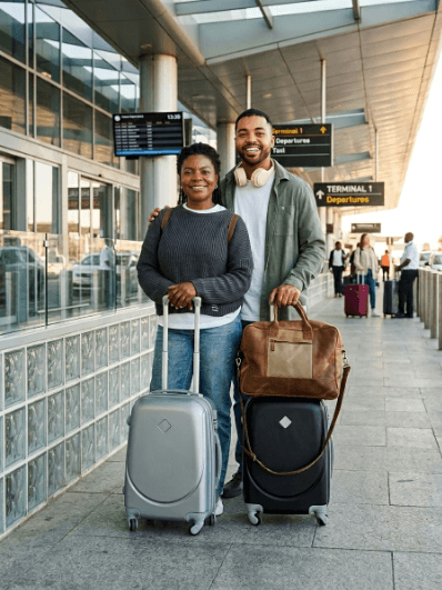 Couple in an airpot with their travelling bags
