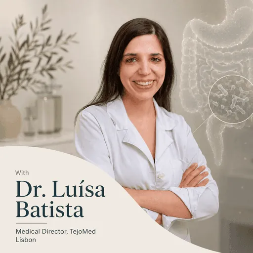 Smiling female family doctor at TejoMed clinic in Lisbon sitting at her desk with a stethoscope and tablet, representing personalized concierge healthcare and patient-centered care.