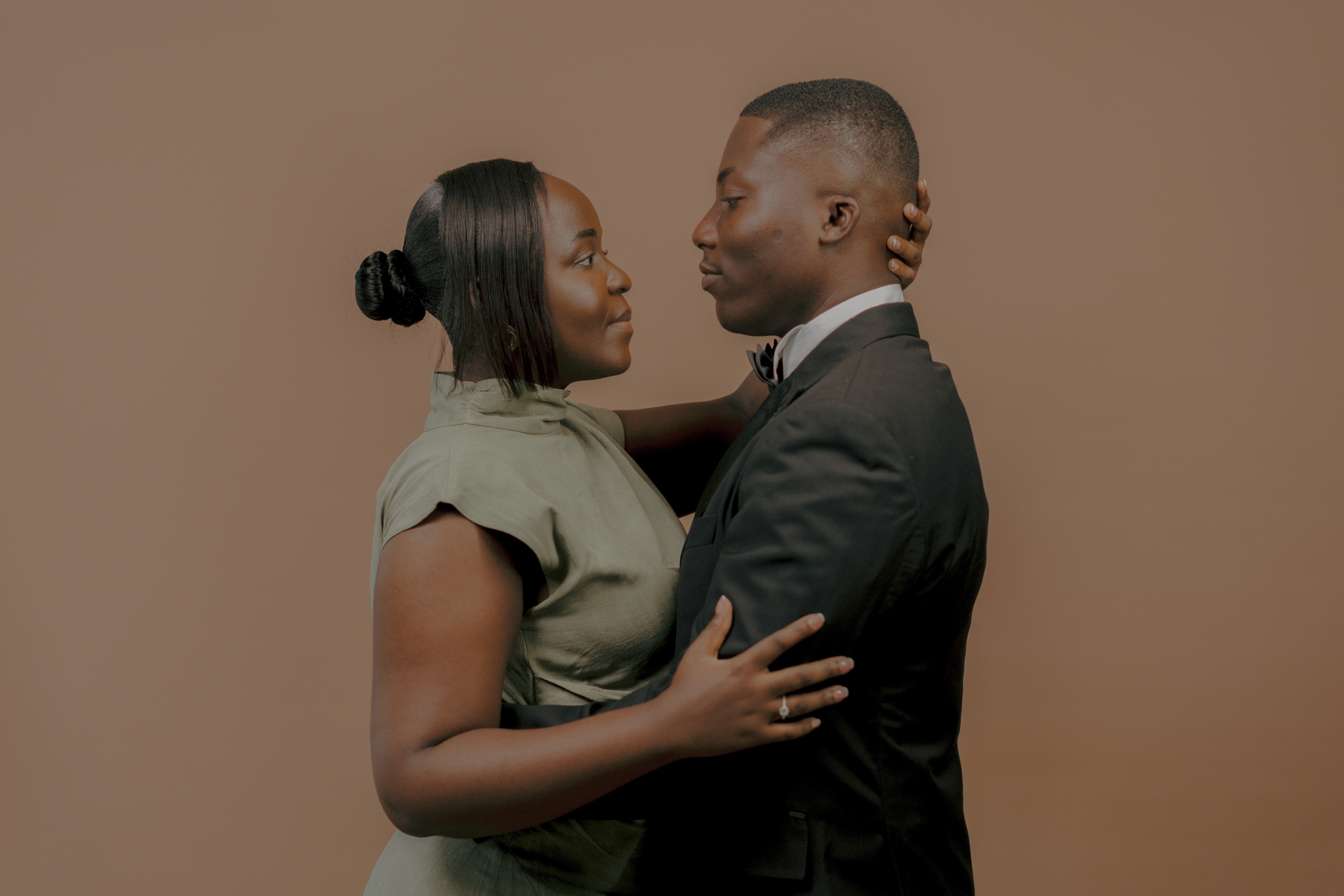 a couple holding hands while standing next to each other