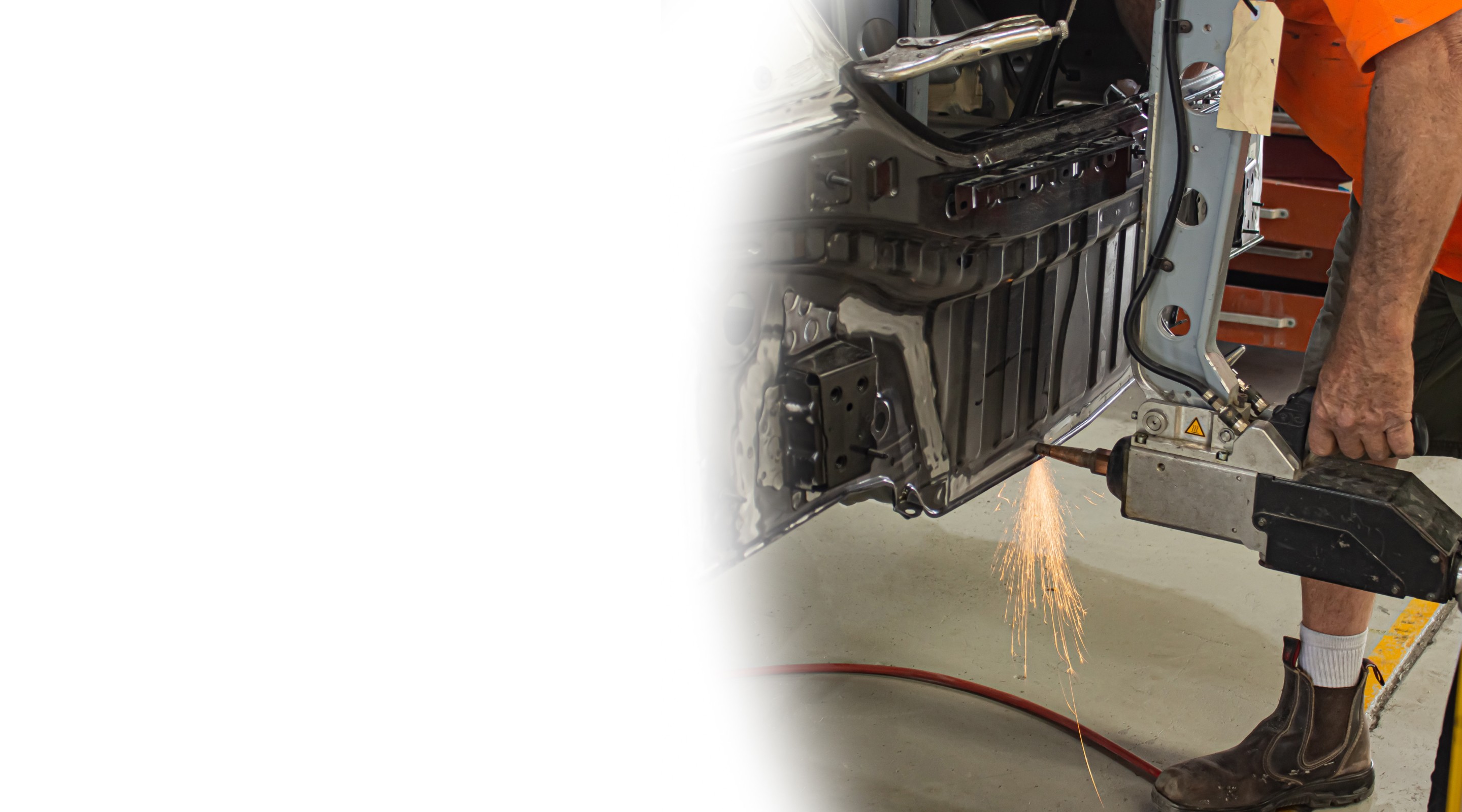 Welding a car frame with sparks flying
