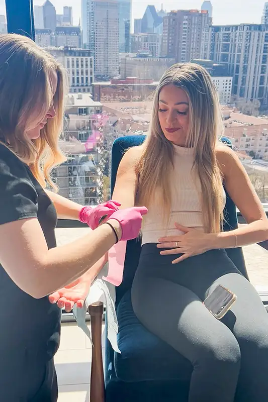 Woman receiving IV therapy