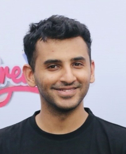 man in gray crew neck t-shirt and gray shorts sitting on basketball court