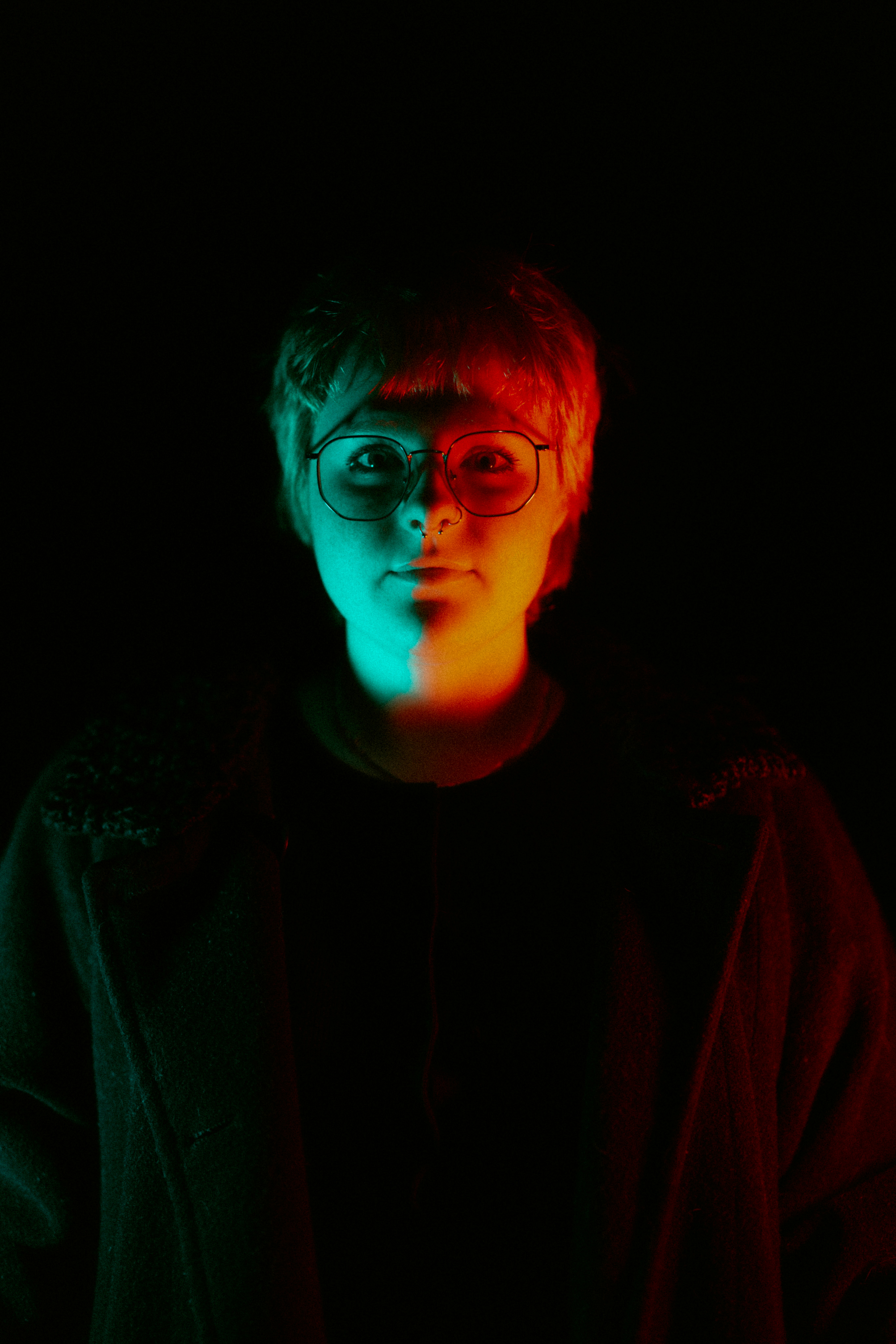 Person illuminated by red and blue light