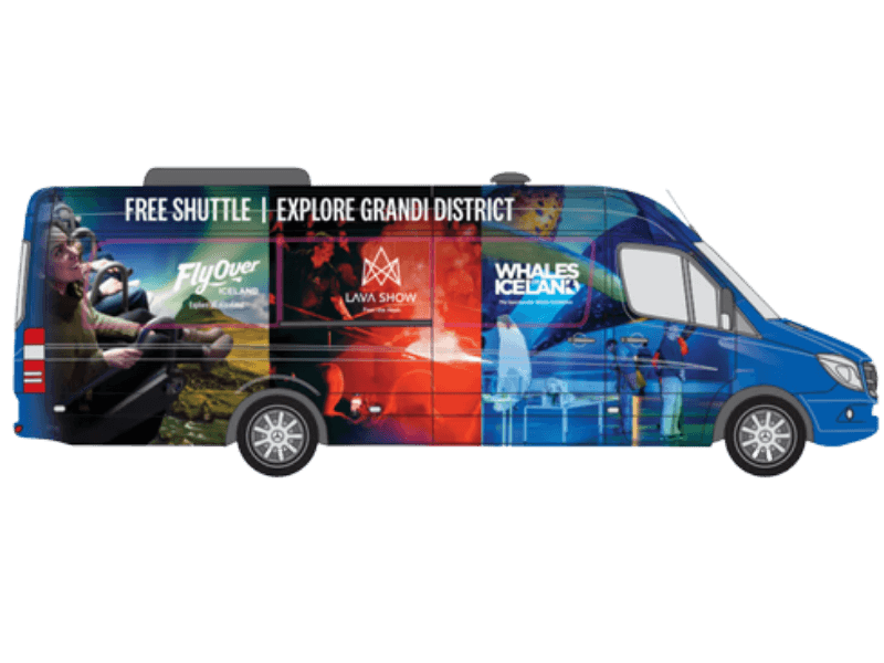 Free Grandi District shuttle bus in Reykjavík branded with Lava Show, FlyOver Iceland, and Whales of Iceland graphics, offering free transport between downtown and the Grandi attractions.