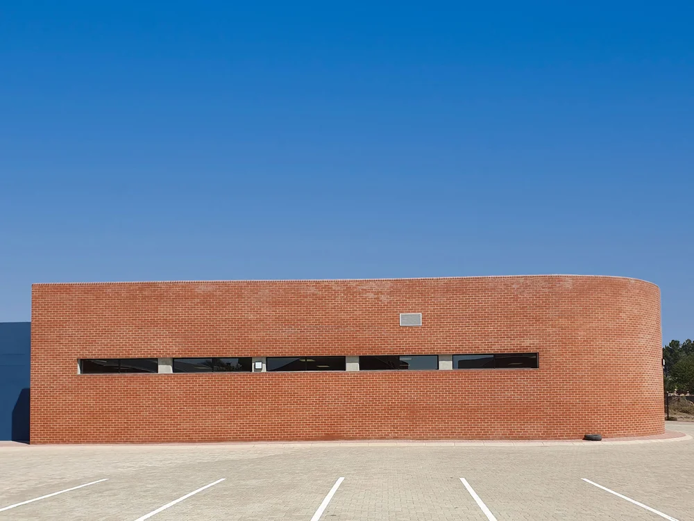 Artistic black and white photo of a person in motion captured in soft blur on white background.  