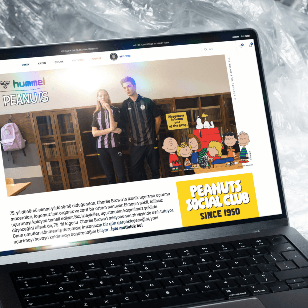 MacBook Pro laptop screen showcasing a website designed for a collaboration between Hummel and Peanuts.