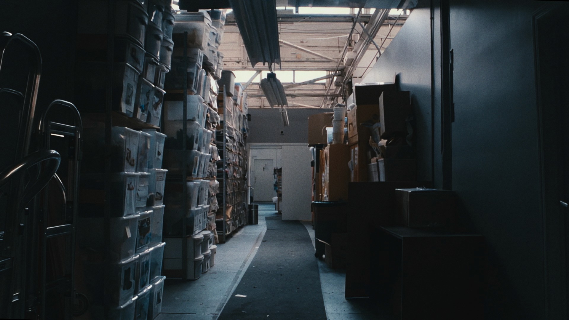 A warehouse aisle stacked high with shoe boxes, Maddman