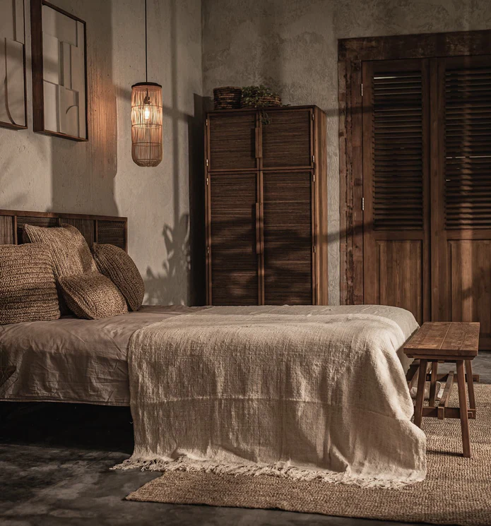Terracotta arches with curved steps and a reflective water basin illuminated by warm light.
