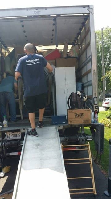 mover carrying boxes inside the van