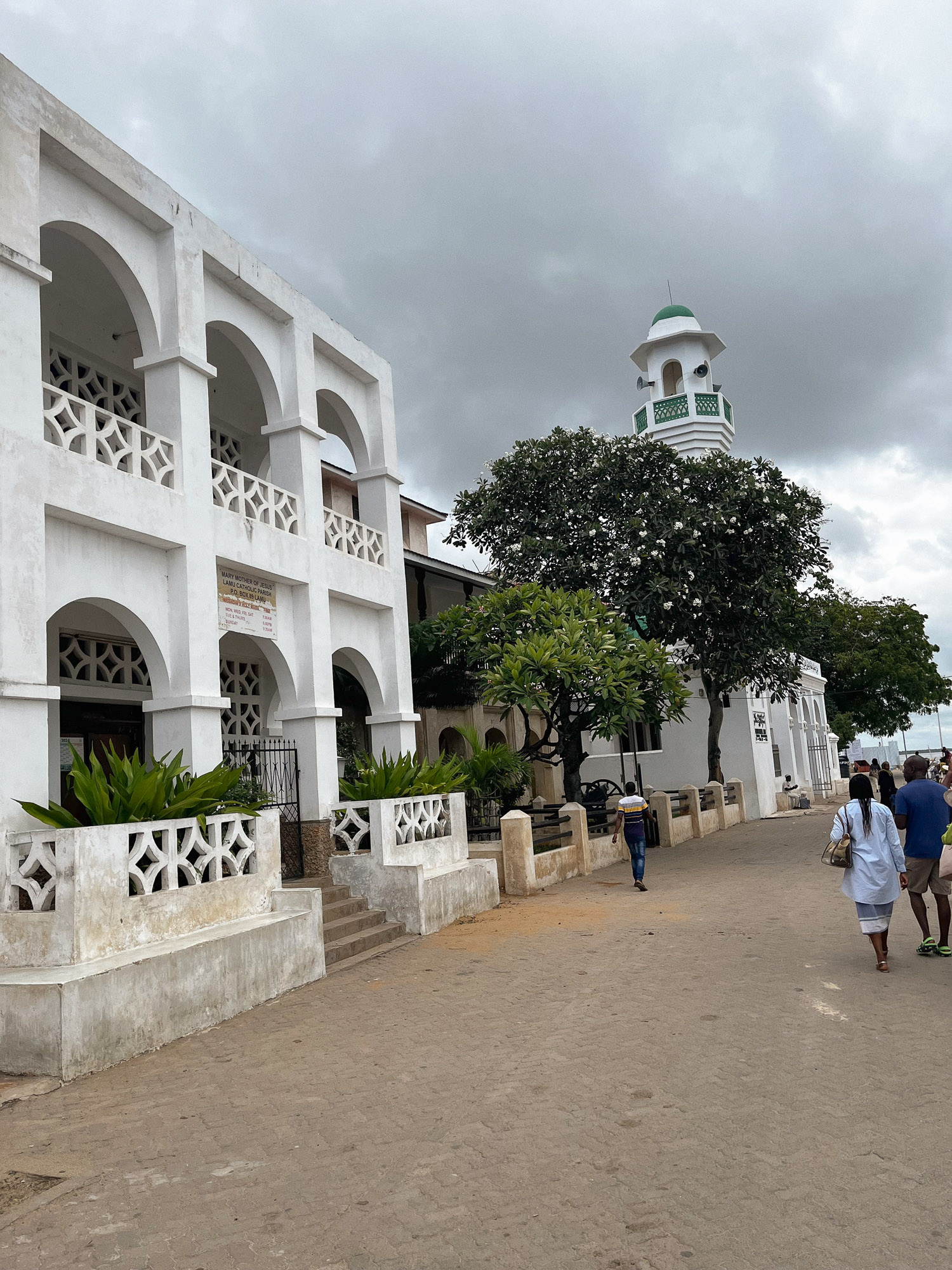 A path with structures including a mosque and church.
