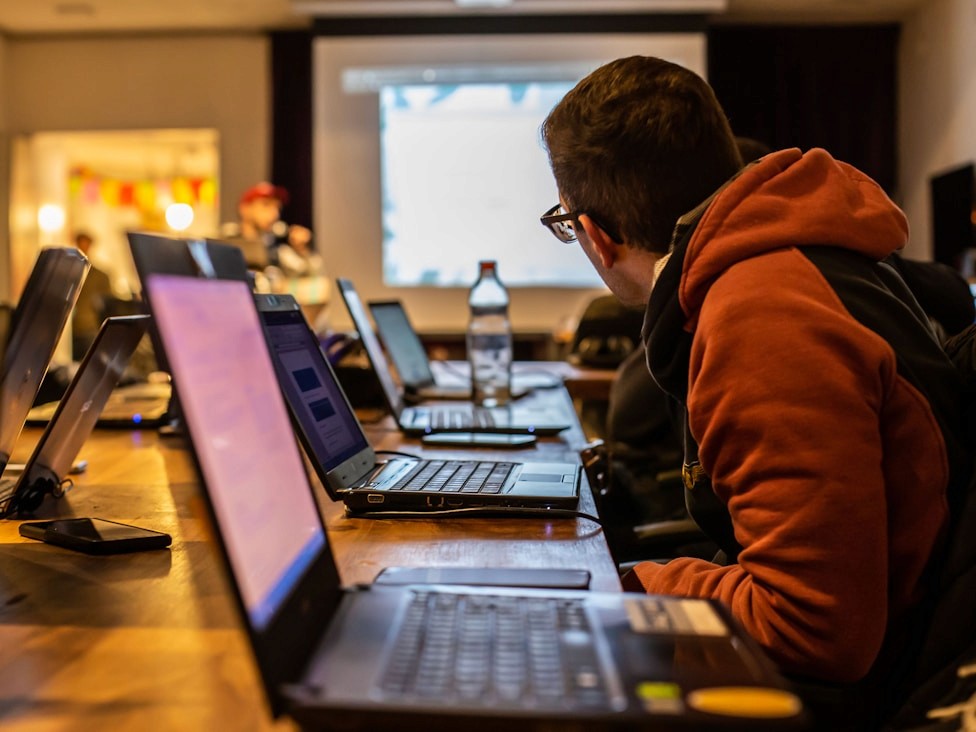 Computer science student working on a laptop