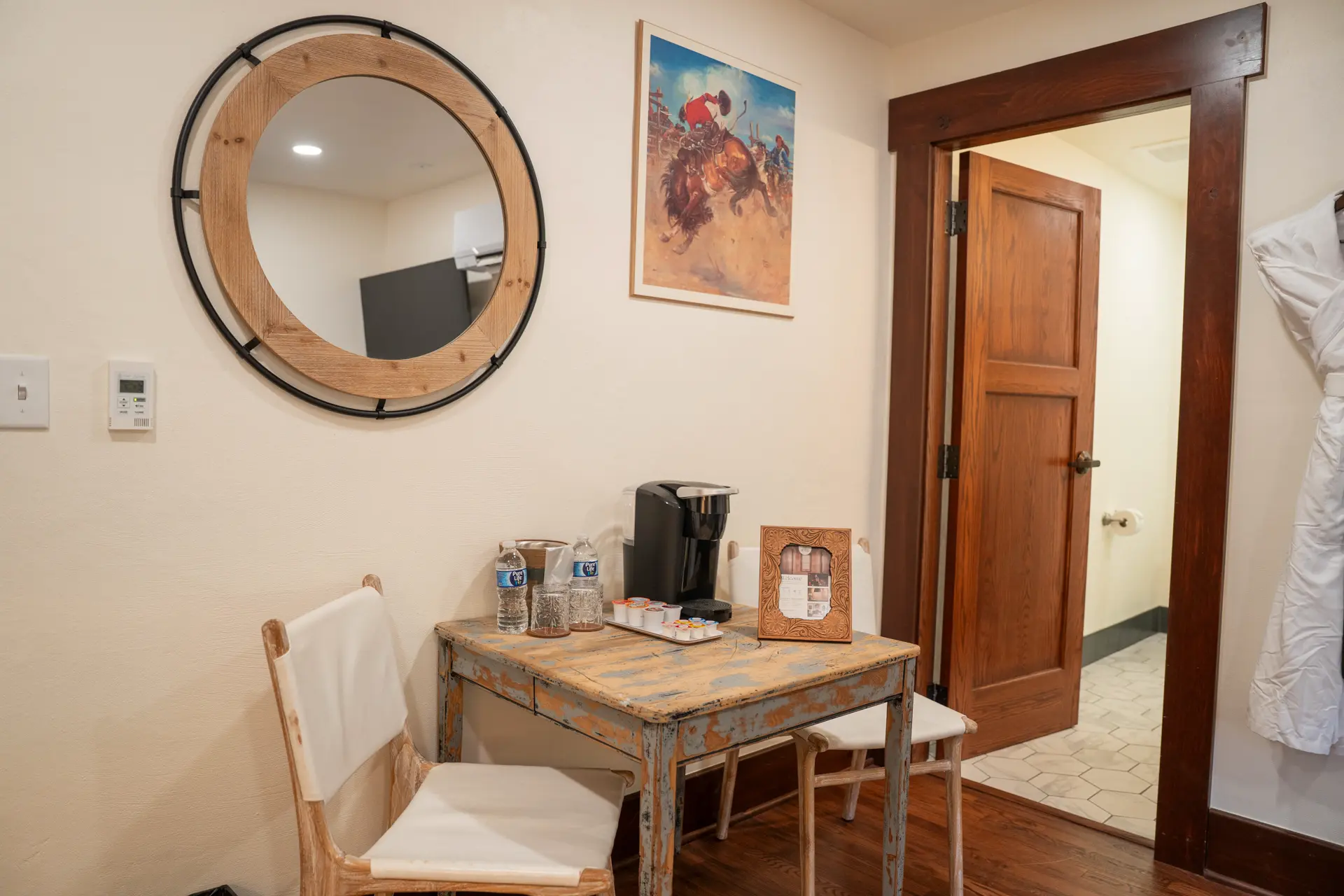 Coffee table, round mirror and rodeo poster