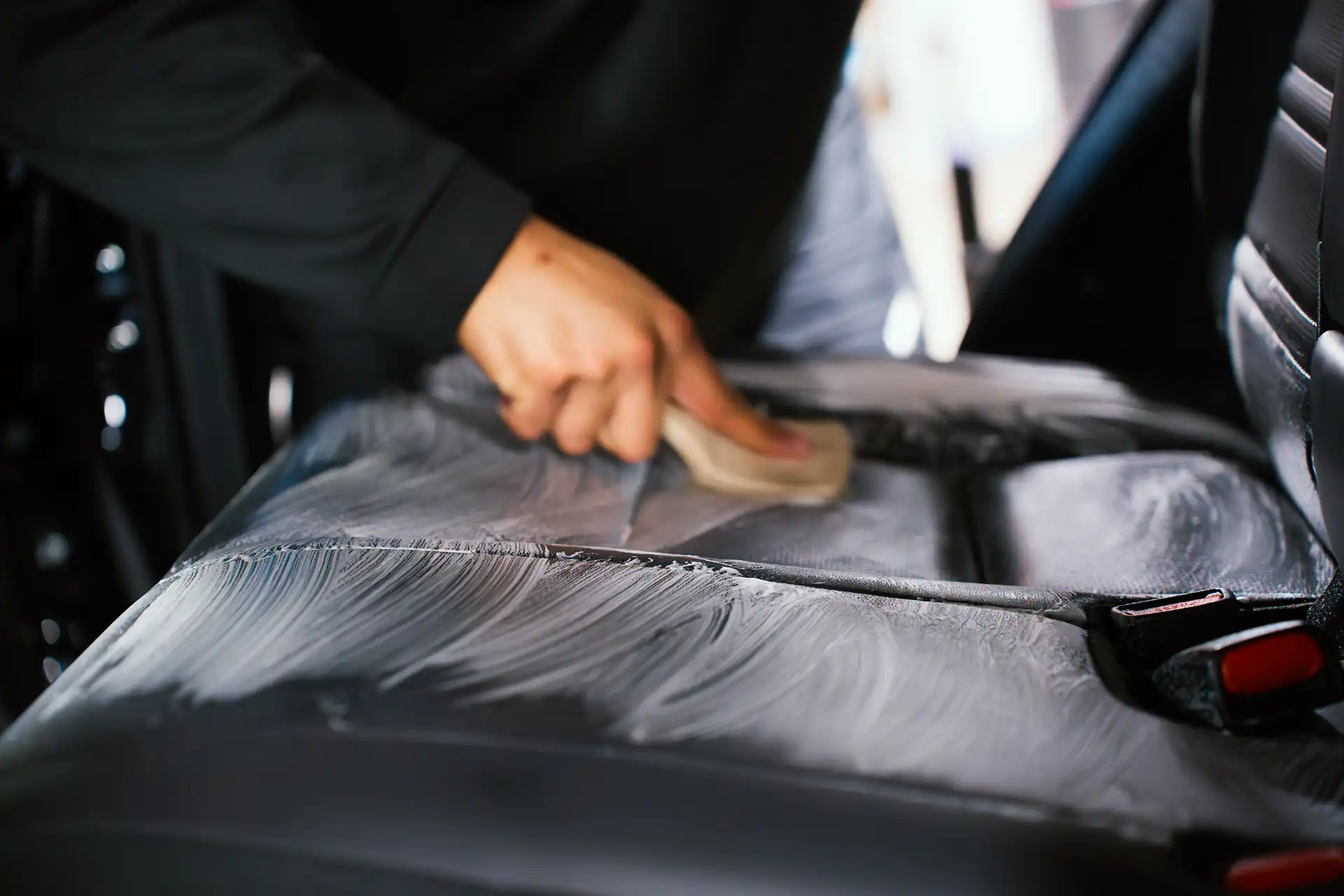  Mechanic pouring fluid into car.