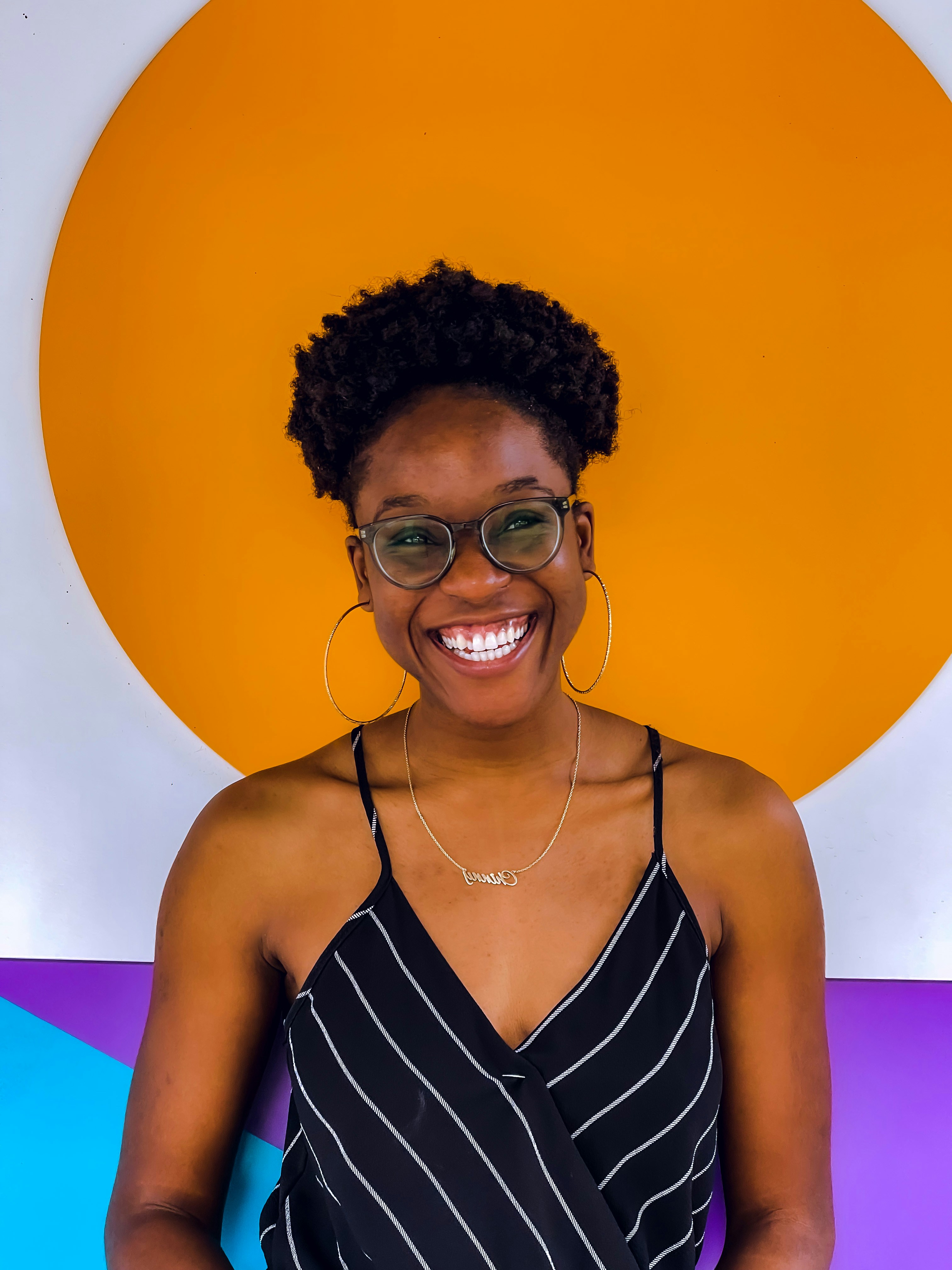 woman in black and white stripe spaghetti strap top wearing eyeglasses