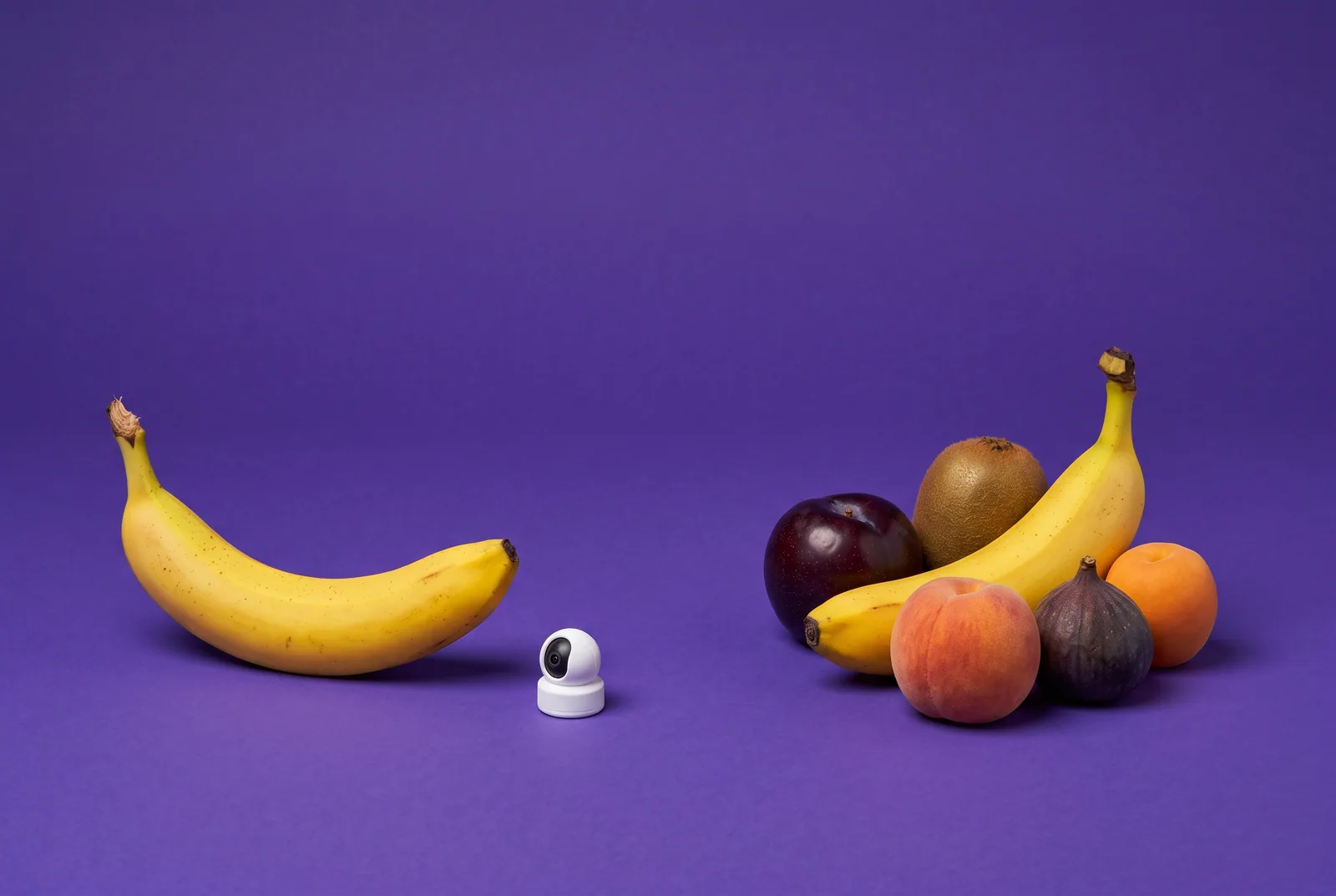 A banana under a tiny camera versus a banana among fruit friends, accountability partner apps vs anonymous community