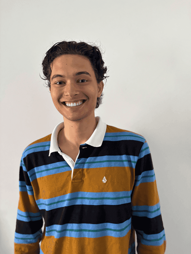 Mateo smiling, wearing a striped rugby shirt.