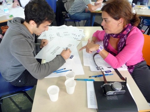 woman on pink shirt teaching man with typography