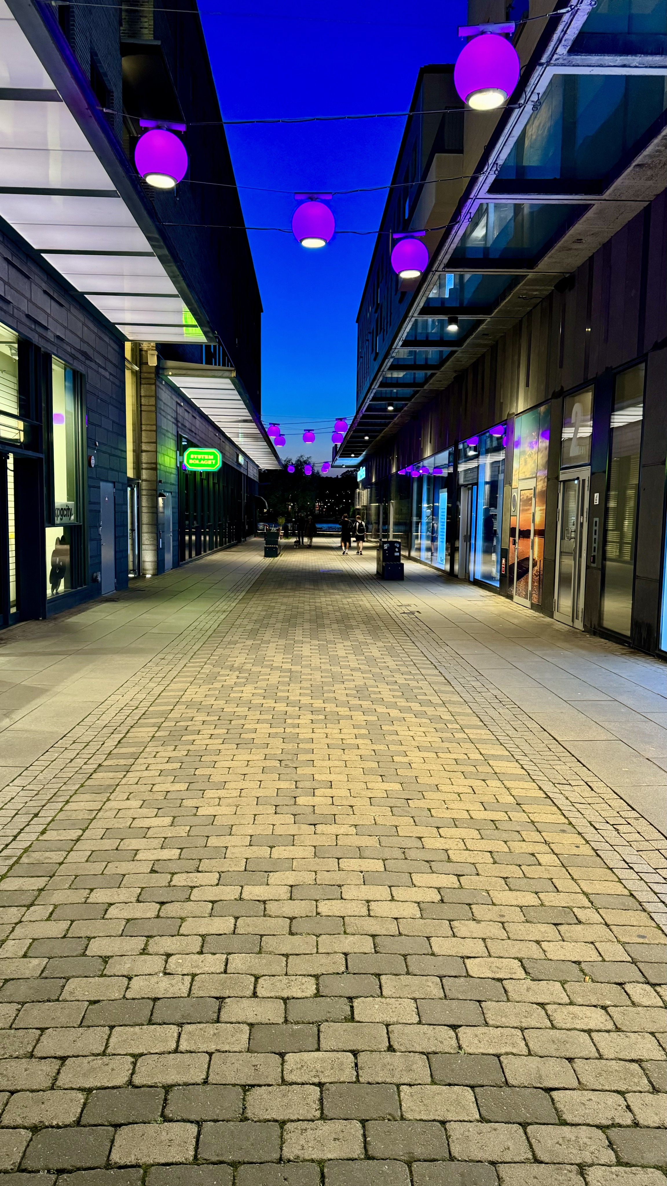 a street at night with blue night sky