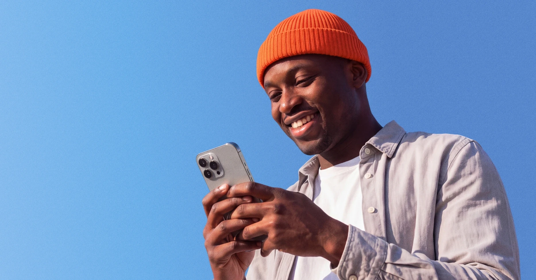 Man smiling while scrolling on his phone