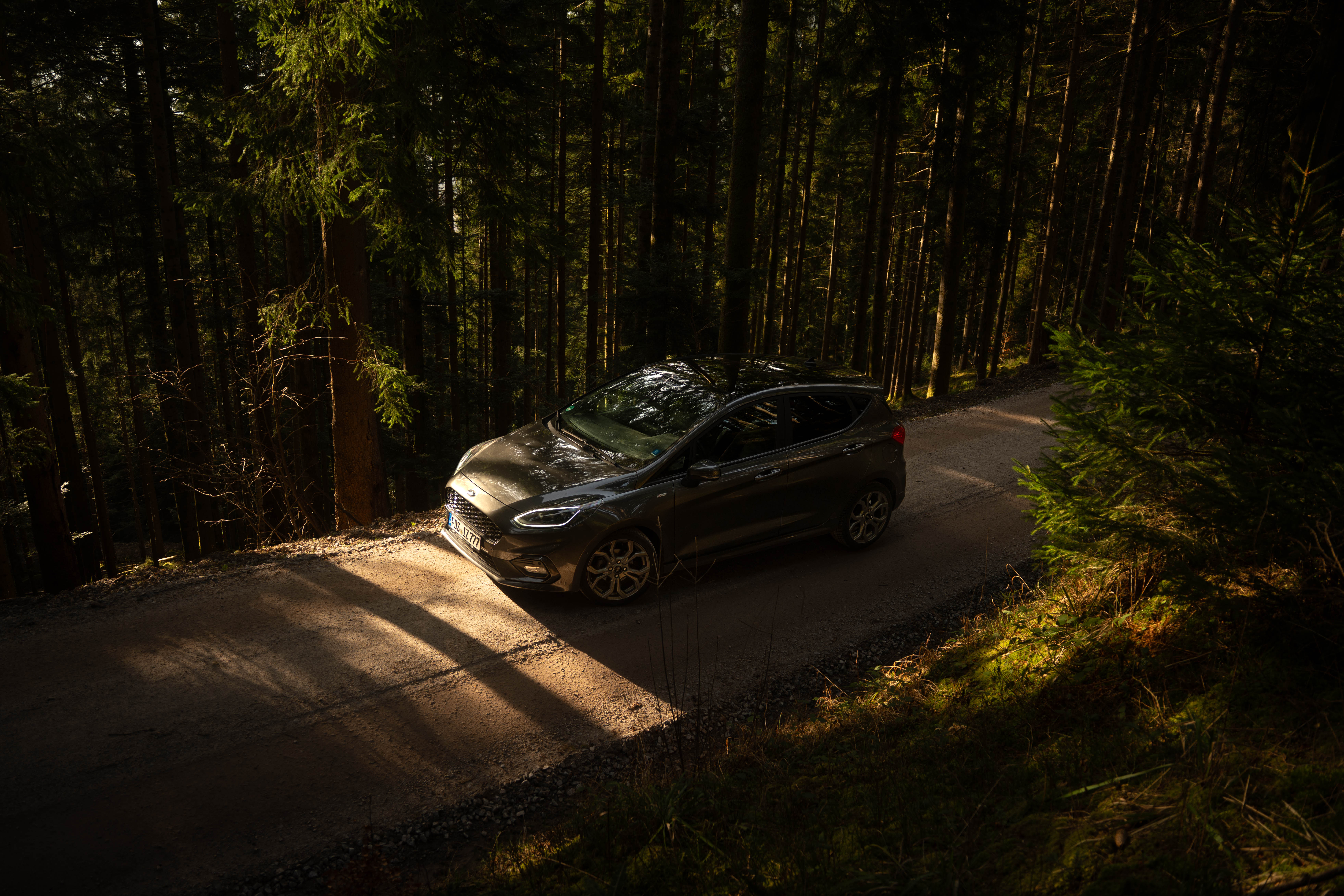 Black cosmetic product bottle against a dark background