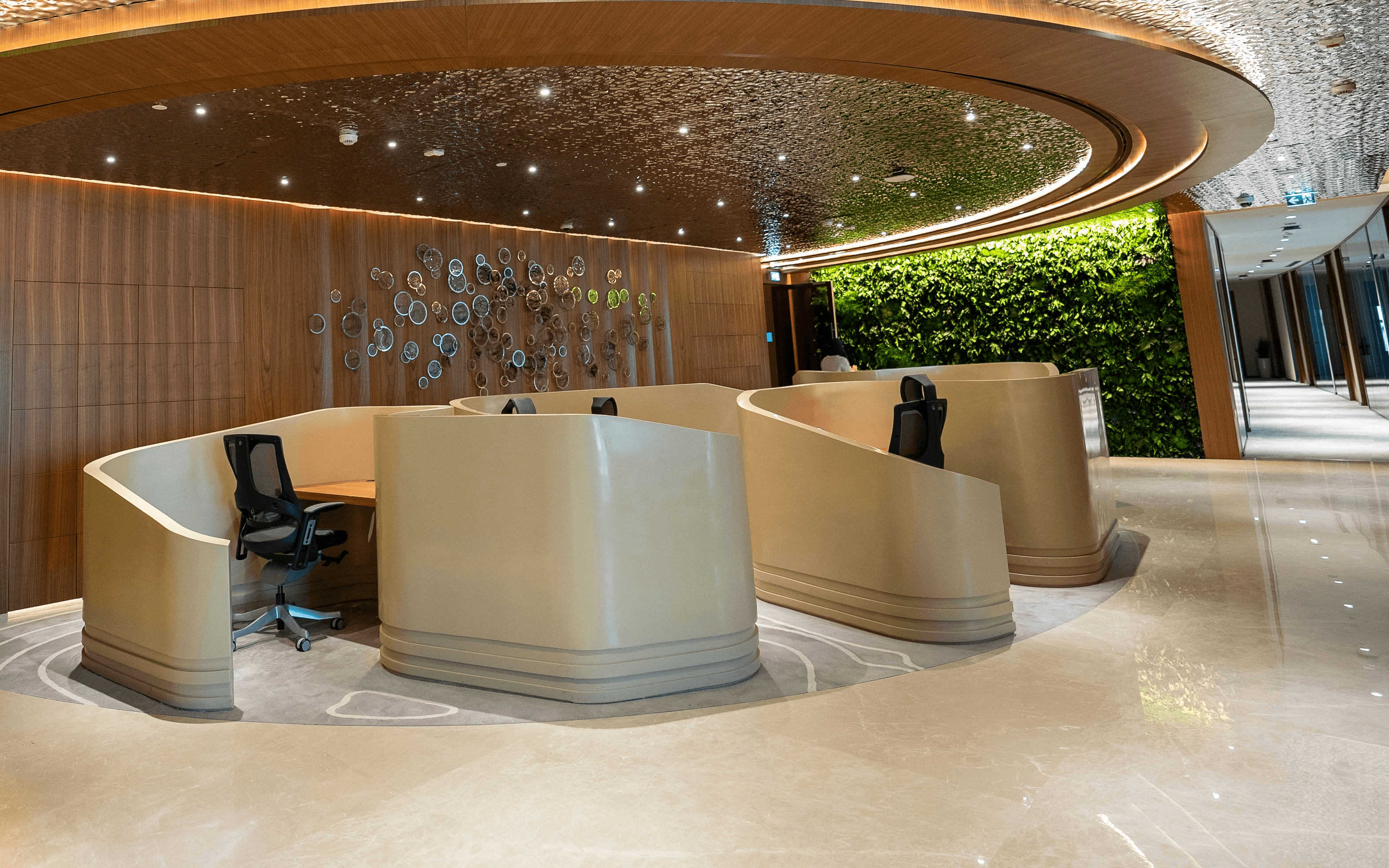 Coworking space at Aldar HQ with natural daylight, waterfront views, and executive desk setups.