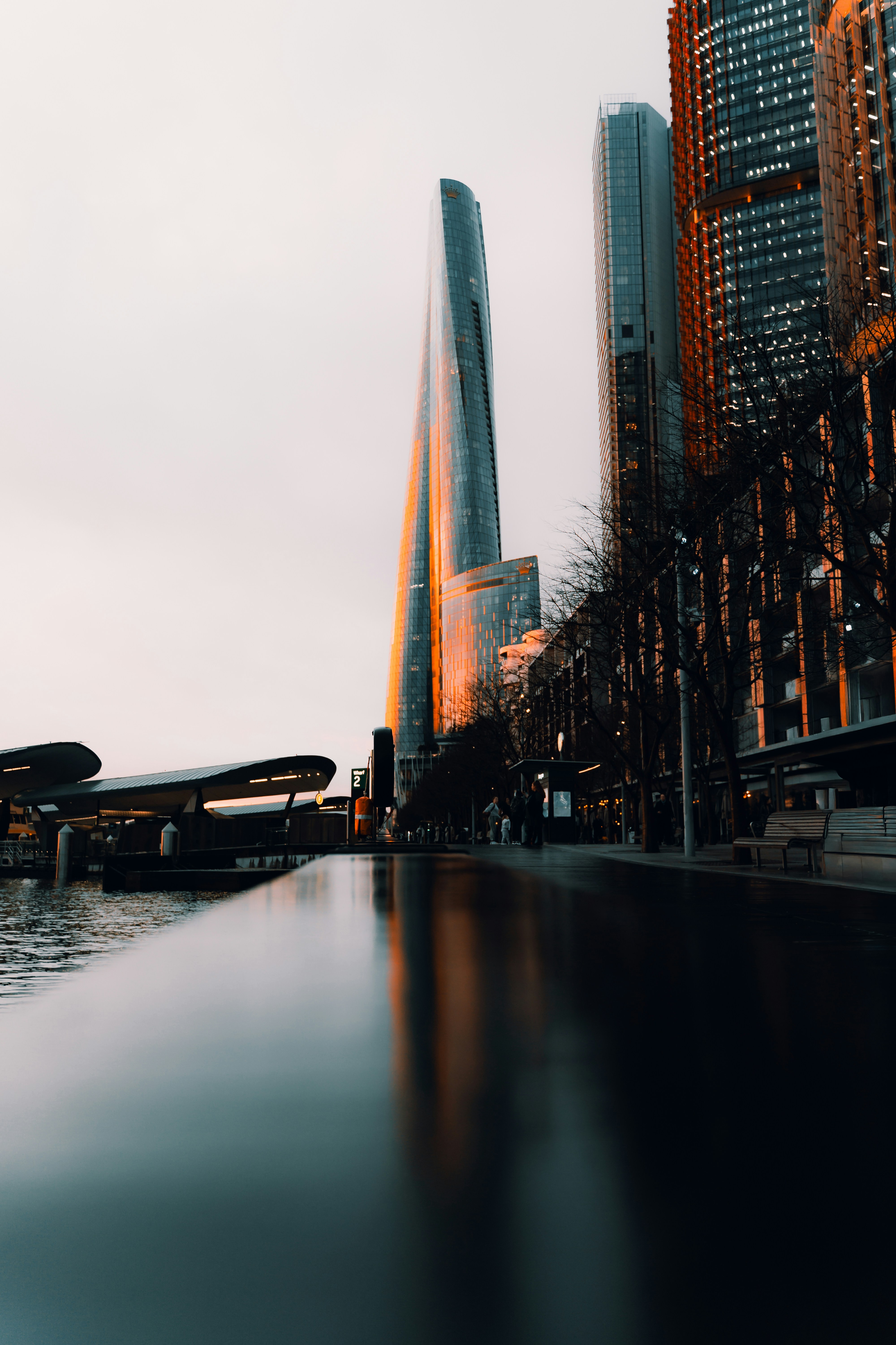Modern skyscrapers reflected in water at dusk