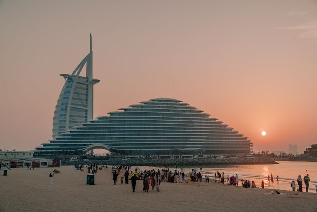 Jumeirah Beach Hotel walkway with people admiring the view of the Burj al Arab.