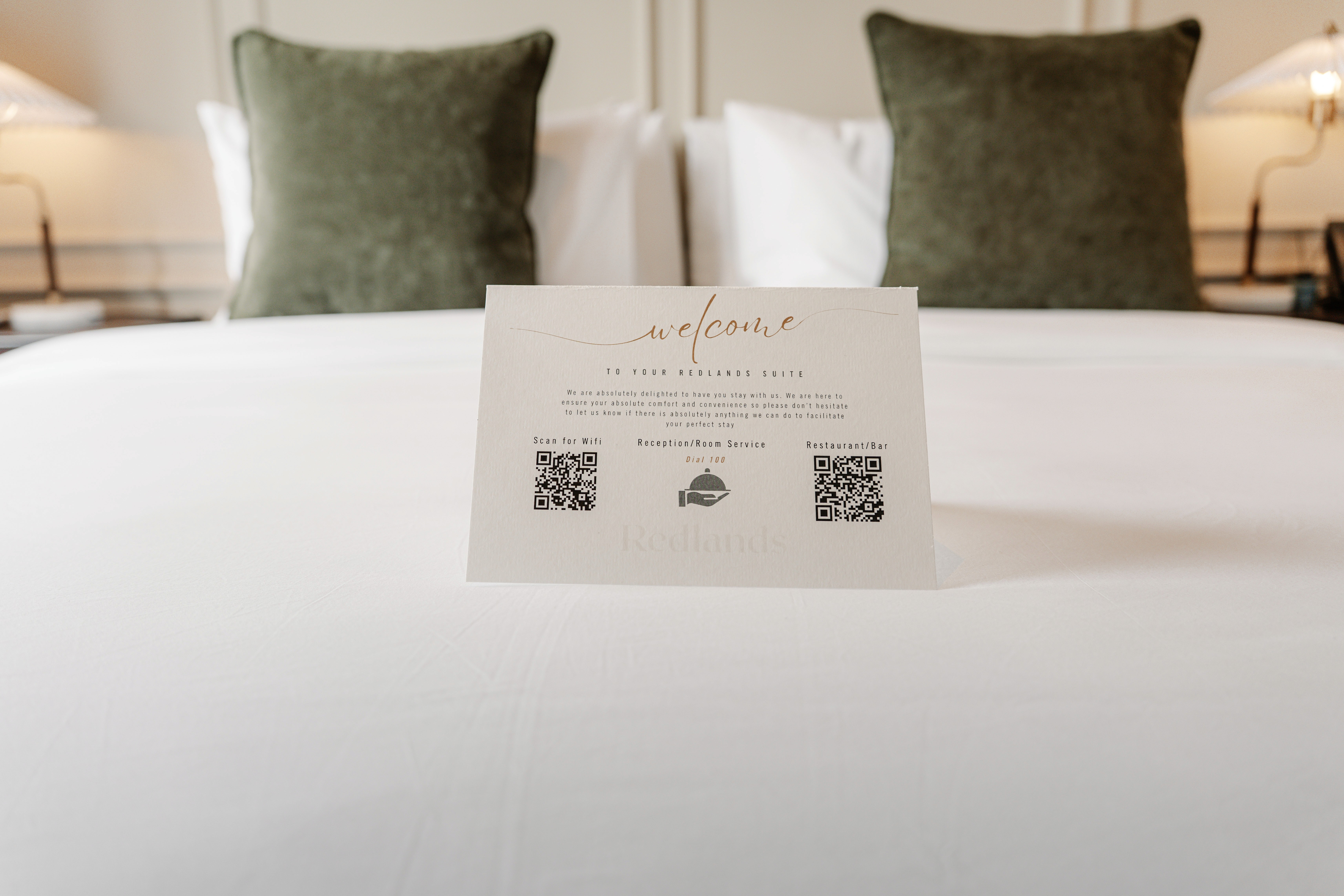 Deluxe Suite at Redlands Hotel with king-size bed, luxury linens, and ensuite bathroom.