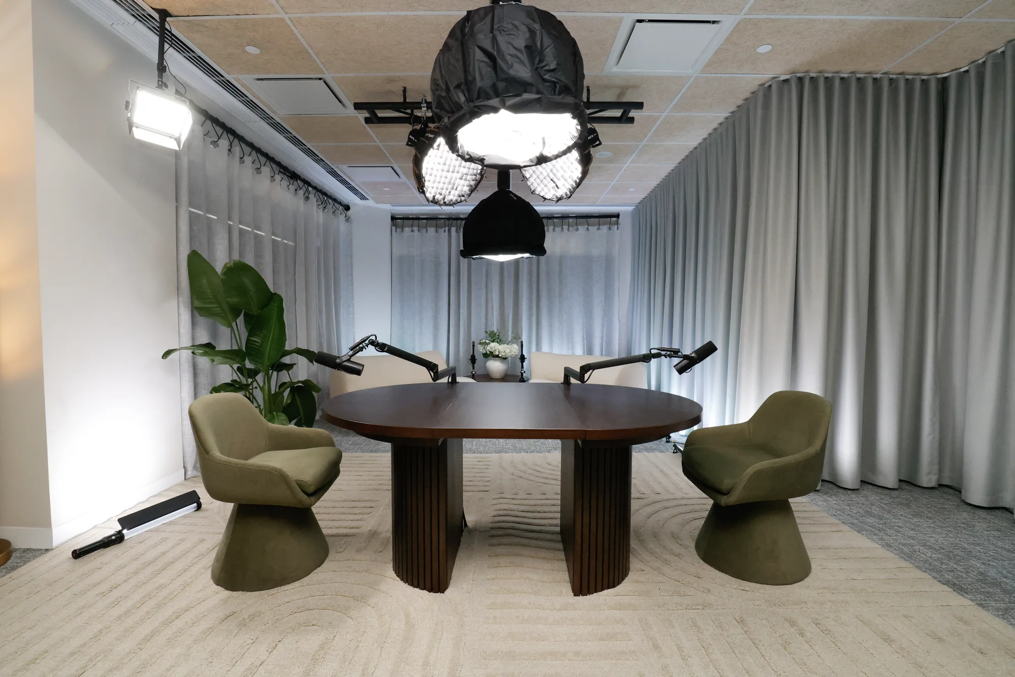 OAK set at Collins Street: a round table with two green chairs, brightly lit