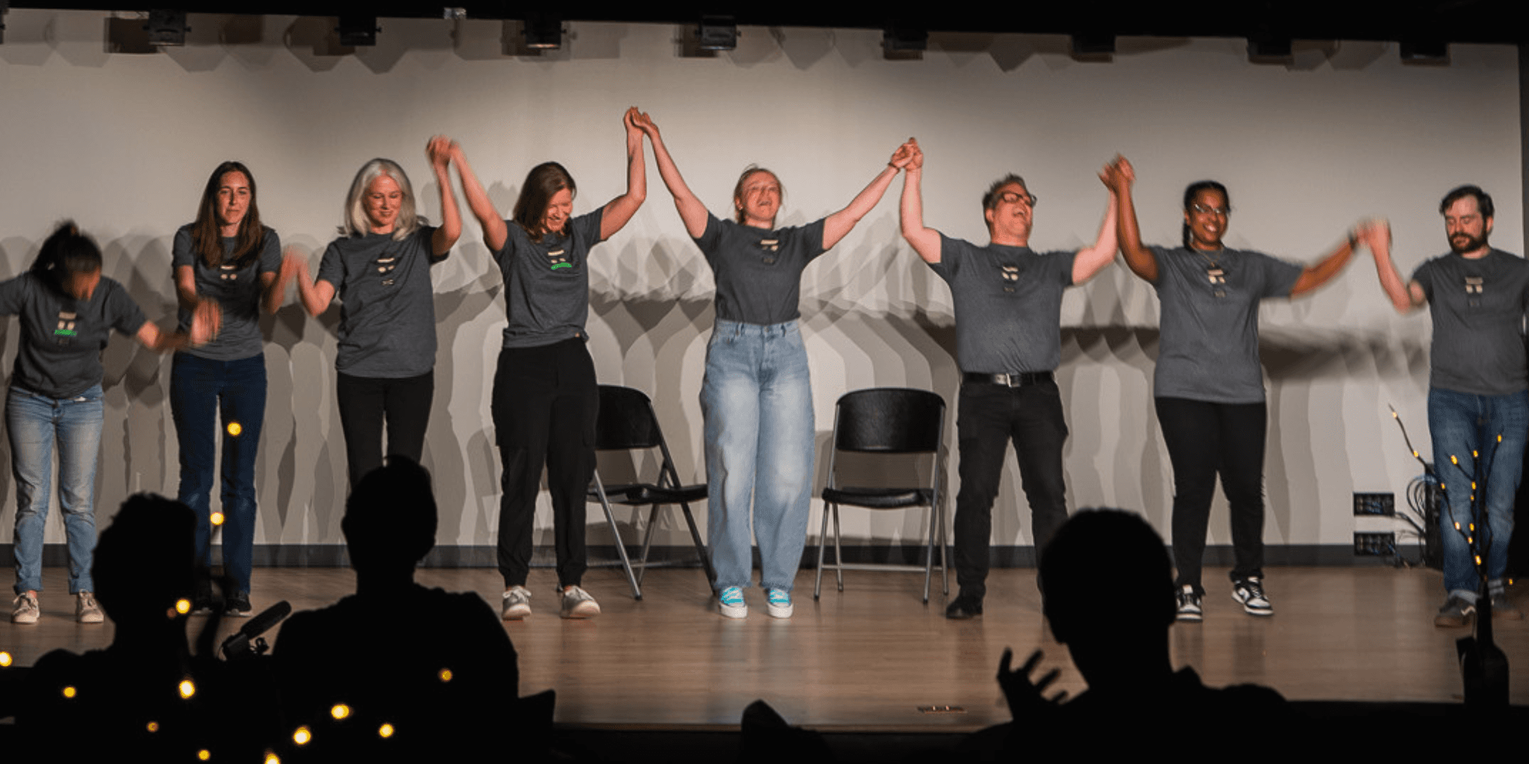 Improv performers laughing and engaging with the audience during a live comedy show at Black Sheep Comedy in Carrboro and Chapel Hill, NC